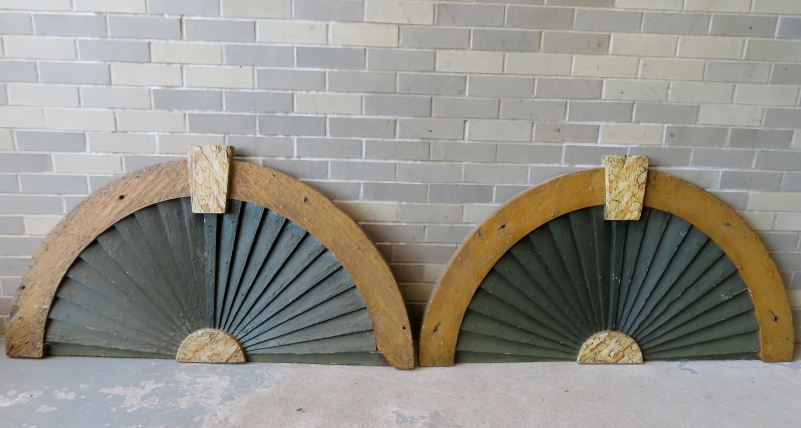 A pair of matching half round carved fan shaped building ornaments, mid 19th century, in old but not: A pair of matching half round carved fan shaped building ornaments, mid 19th century, in old but not original mustard and grain paint. Both in very good condition. Each approximately 50"W x 26 3/4"H x