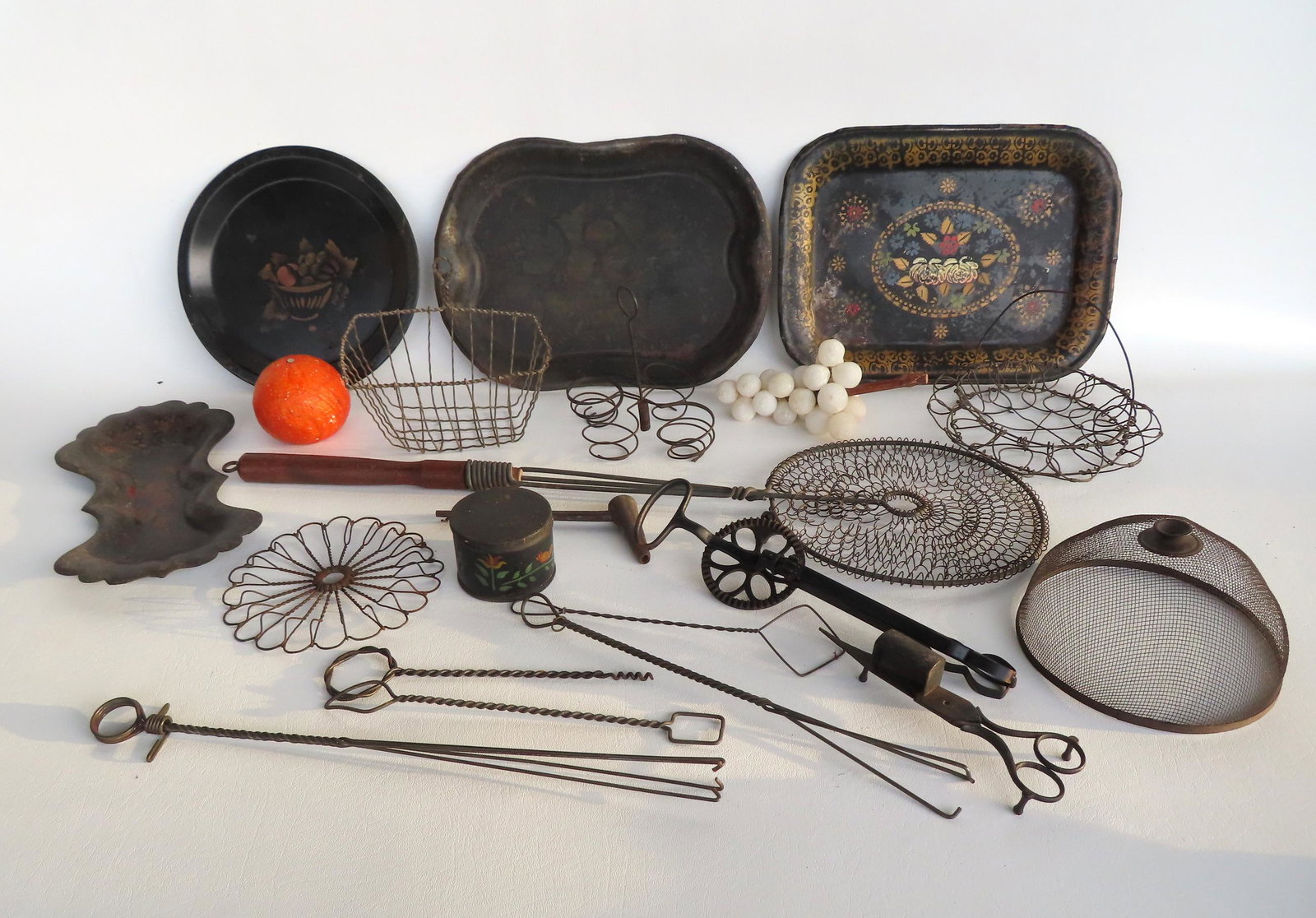 Grouping of country items including: Small wire pie cover, wire egg boiler to hold 4 eggs, stone: Grouping of country items including: Small wire pie cover, wire egg boiler to hold 4 eggs, stone grapes on real grape vine, wire soap basket, wire trivet, wire basket shaped egg boiler, long handled w