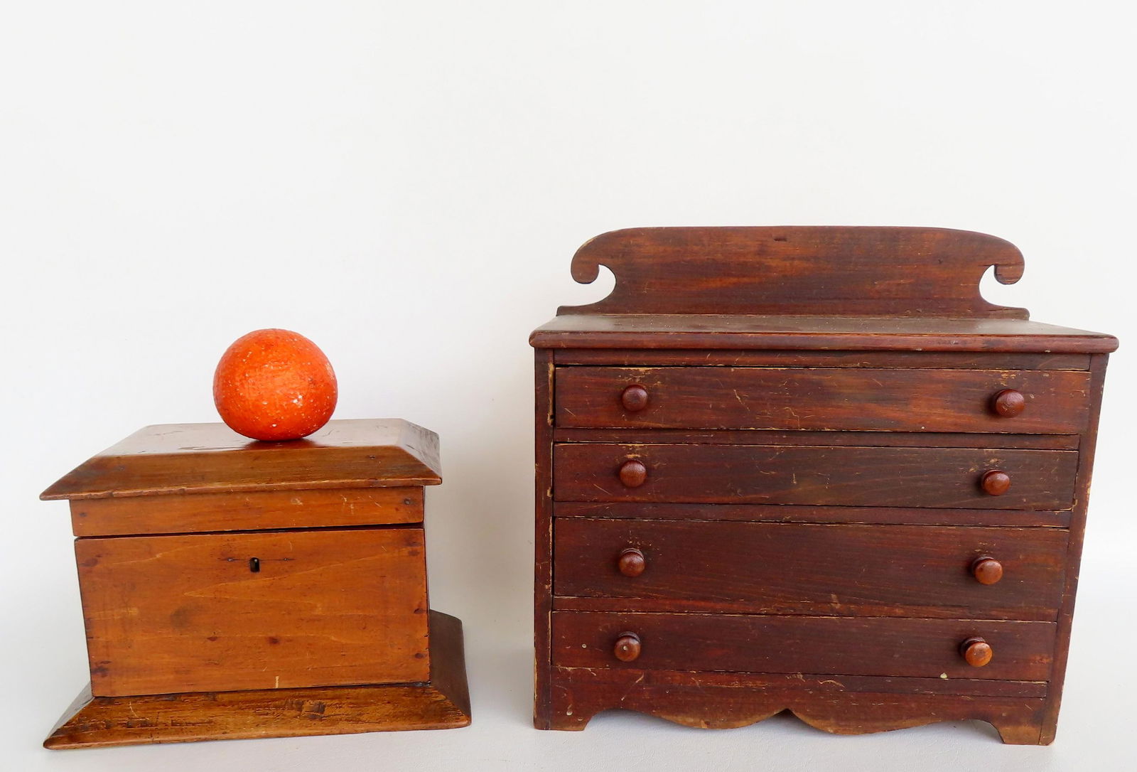 A doll size chest of drawers and a wooden sewing box. The former, having 4 drawers (top 3 graduated: A doll size chest of drawers and a wooden sewing box. The former, having 4 drawers (top 3 graduated sizes) and shaped backsplash, original red stain, on cutout base - good condition - 12 1/2"W x 6 1/2