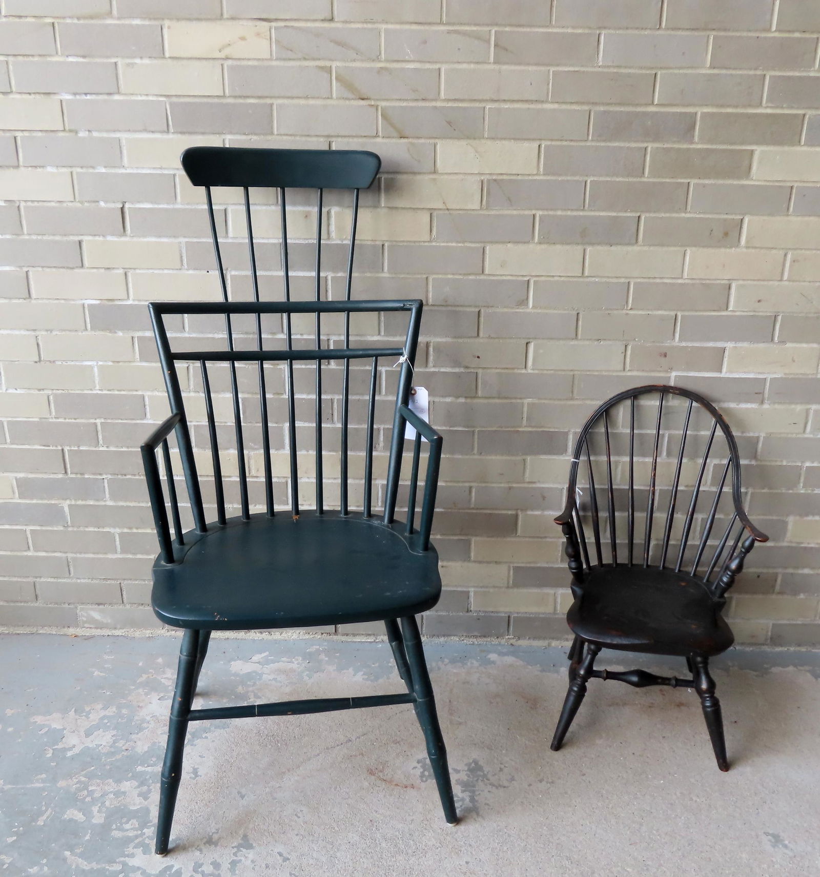 Two custom made Windsor chairs, 20th century. The first a child's continuous arm Windsor in original: Two custom made Windsor chairs, 20th century. The first a child's continuous arm Windsor in original black paint, splayed legs attached by bulbous cross stretchers and signed "R. Barrow 1696" - origin