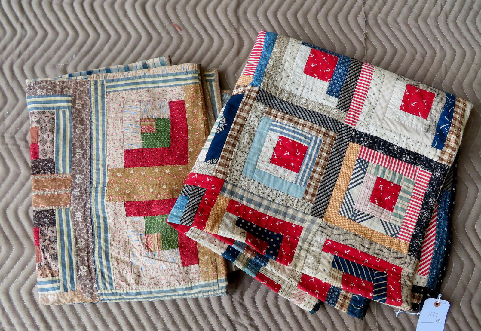 Two log cabin quilts including: The first, late 19th to early 20th century, hand sewn but with: Two log cabin quilts including: The first, late 19th to early 20th century, hand sewn but with machine sewn backing - very good condition - 78" x 80"; the second, circa 1900, with newer backing - stai