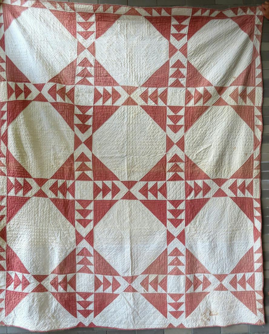 Patchwork quilt, Flying Geese variation with sawtooth border, late 19th century. The backing: Patchwork quilt, Flying Geese variation with sawtooth border, late 19th century. The backing composed of seed or feed sacks, one marked "Charter Oak". Some stains, otherwise good condition. 78" x 91".