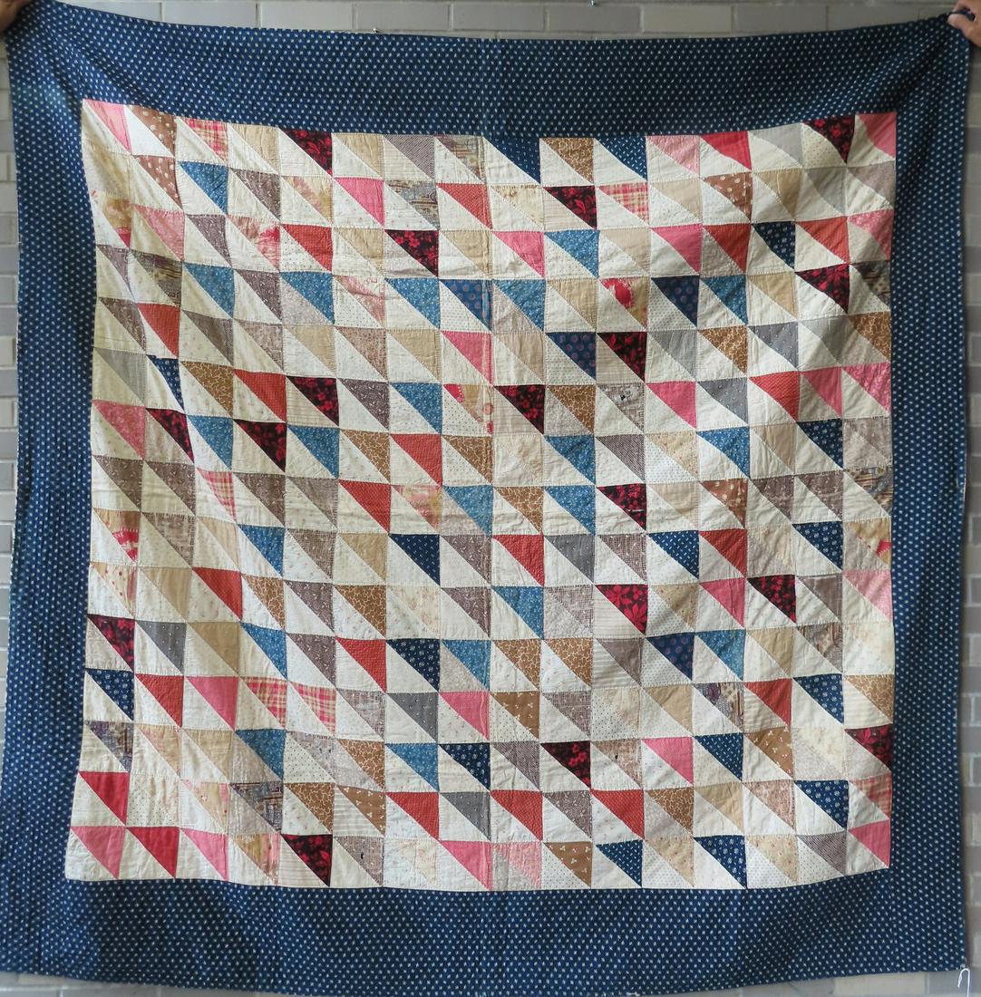 Patchwork quilt, hand sewn, Flying Geese pattern with blue and white border, circa 1900. Minor wear: Patchwork quilt, hand sewn, Flying Geese pattern with blue and white border, circa 1900. Minor wear and losses along edge, several patches with fabric fraying, else good condition. Measures 83" x 84".