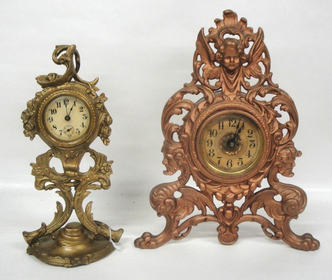 Two ornate French-style cast iron windup mantel clo: Two ornate French-style cast iron windup mantel clocks - one with angel finial - both probably late 19th c. - in older gold paint