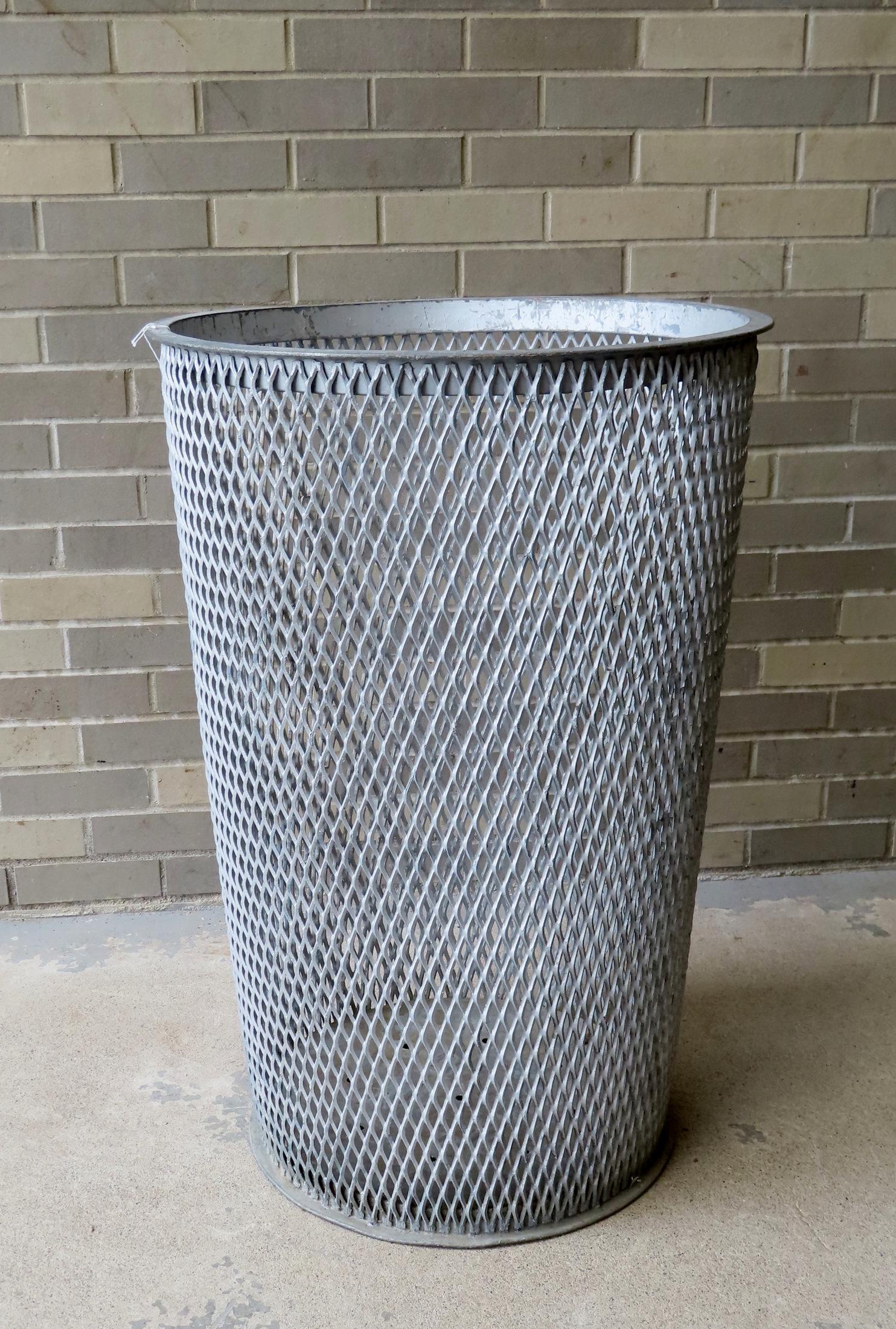 A large industrial cast iron mid-century waste basket with mesh body from the Dept. of Sanitation, (1 of 3)