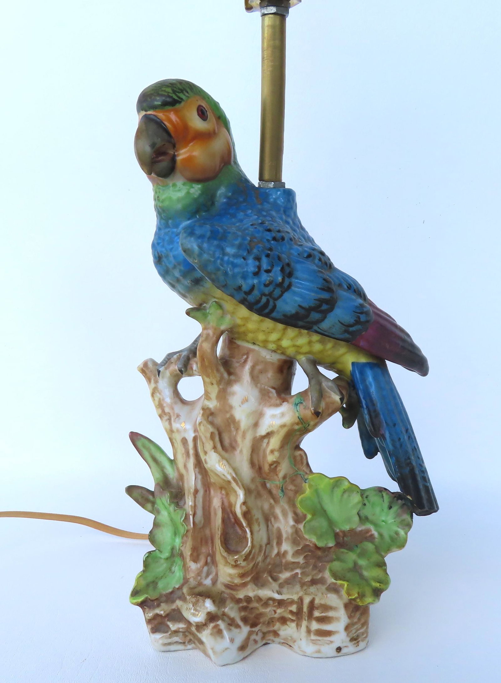 A colorful majolica parrot lamp, probably early 20th century. A tiny flake towards the end of the: A colorful majolica parrot lamp, probably early 20th century. A tiny flake towards the end of the parrot's tail, hardly noticeable, else very good condition with no other damage or repairs. Measures 7
