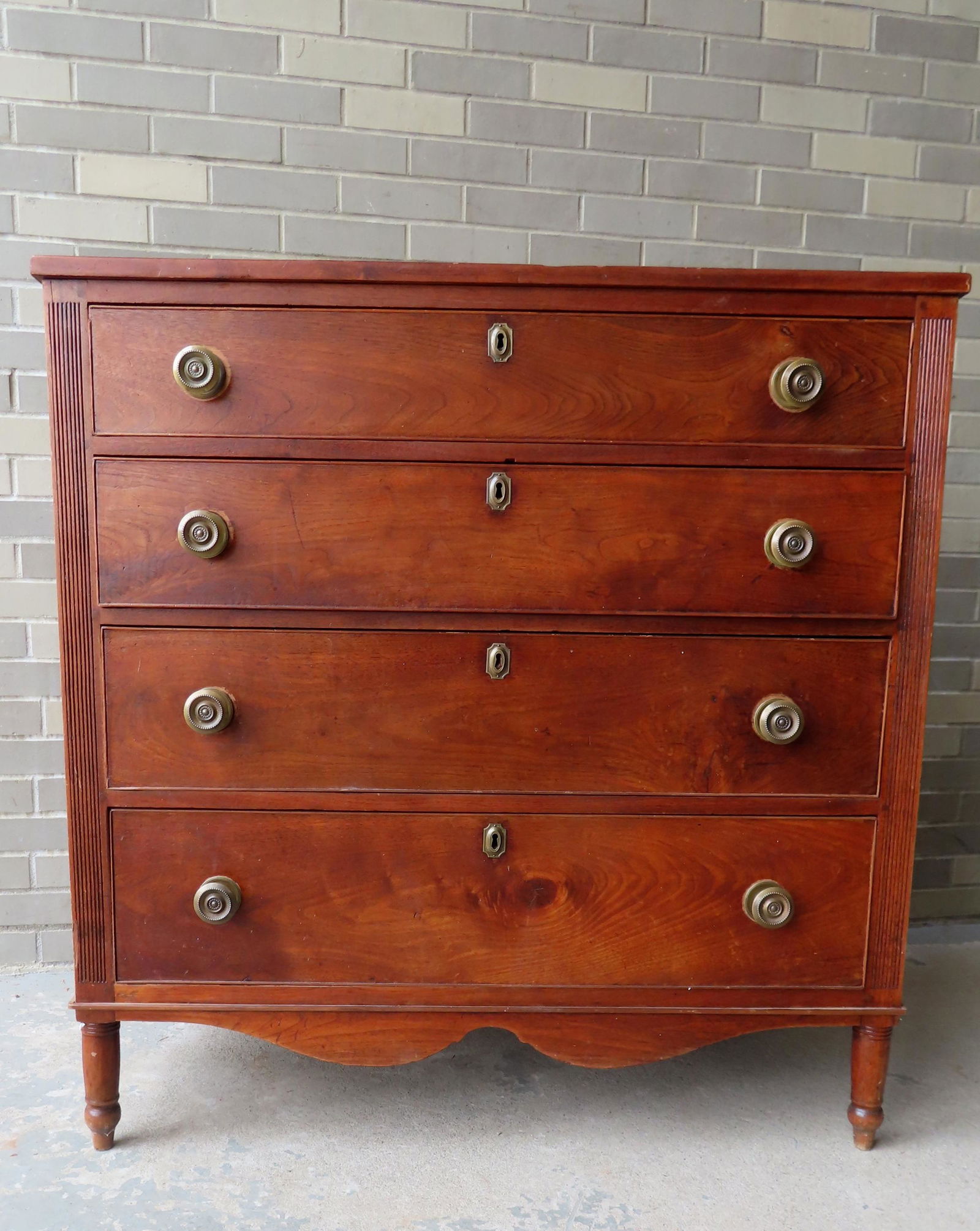 A Pennsylvania black walnut Sheraton chest having 4 graduated drawers, all with matching brass (1 of 10)