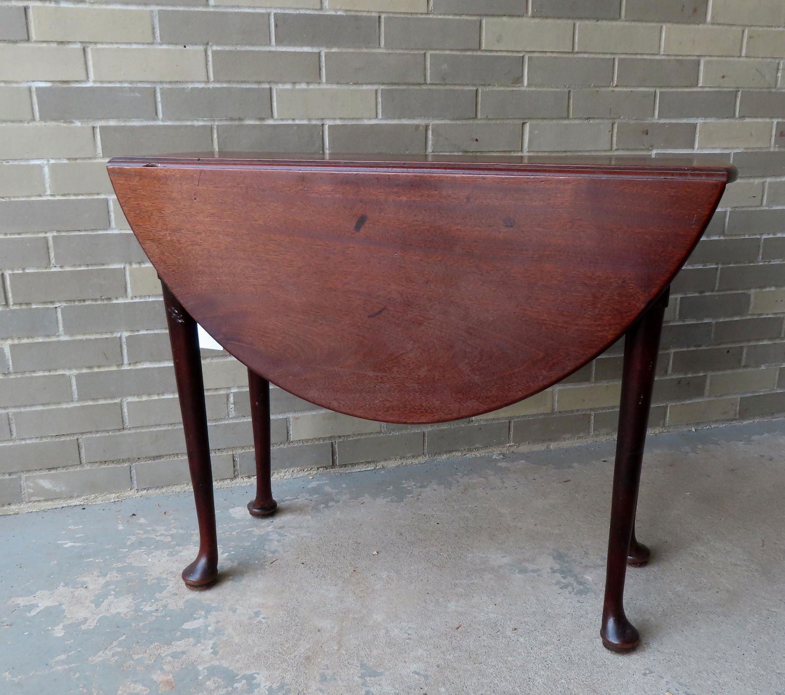 A petit walnut Queen Ann drop-leaf tea table with swing legs and having drawers on each end - the: A petit walnut Queen Ann drop-leaf tea table with swing legs and having drawers on each end - the pulls appear to be original - legs tapered to pad feet. Probably English, 18th century. Measures 13 1/