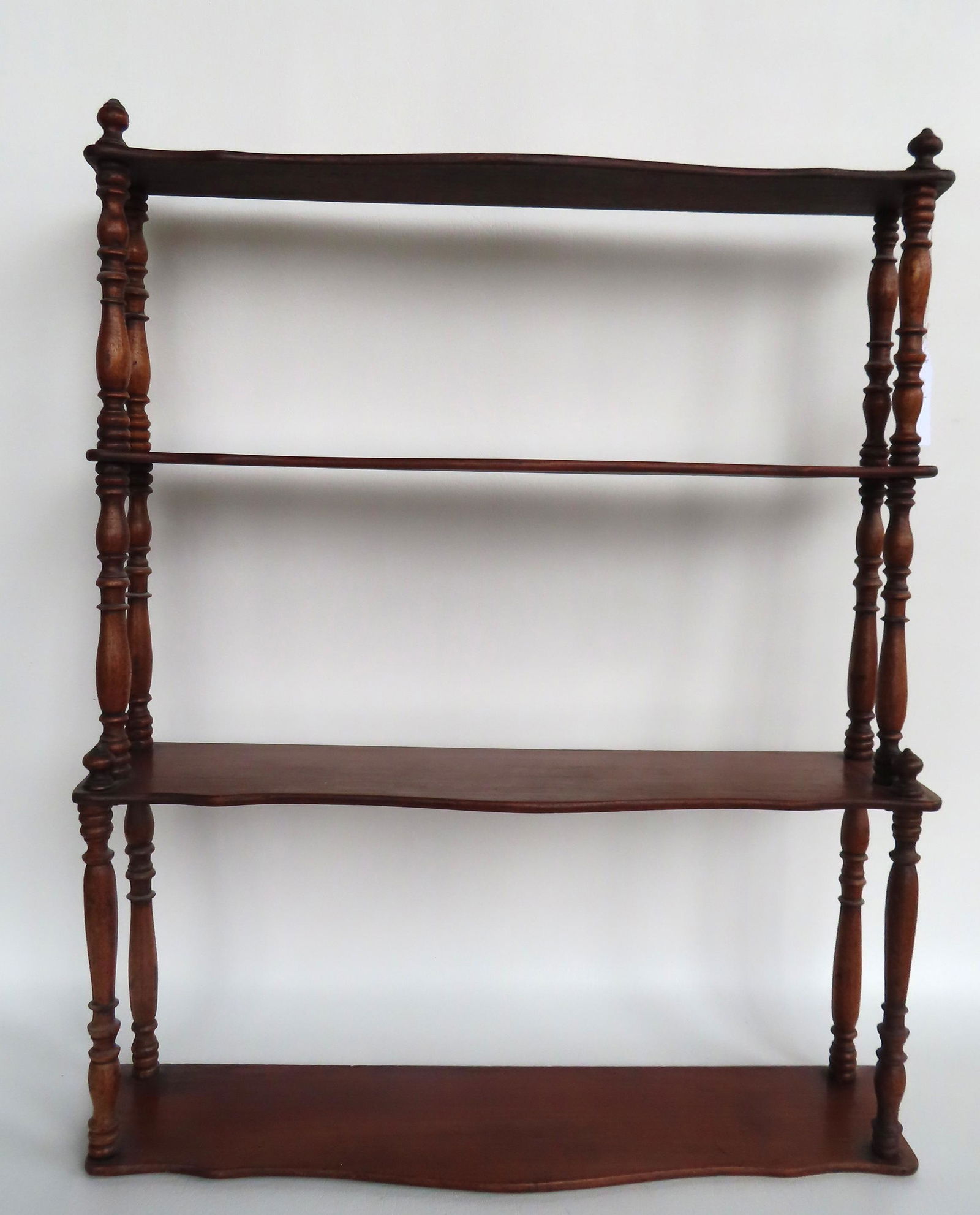 An early wall hanging shelf with 4 graduated serpentine tiers supported by turned columns, mid 19th (1 of 6)