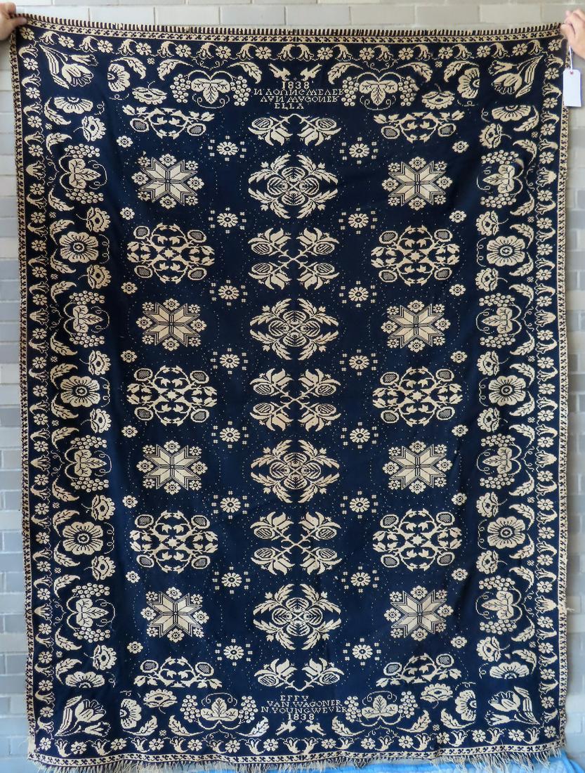 An unusual NJ Jacquard blue and white one piece coverlet decorated with various floral patterns and: An unusual NJ Jacquard blue and white one piece coverlet decorated with various floral patterns and having a double floral border - signed on the center bottoms of both ends "Effy Van Wagner / N. Youn