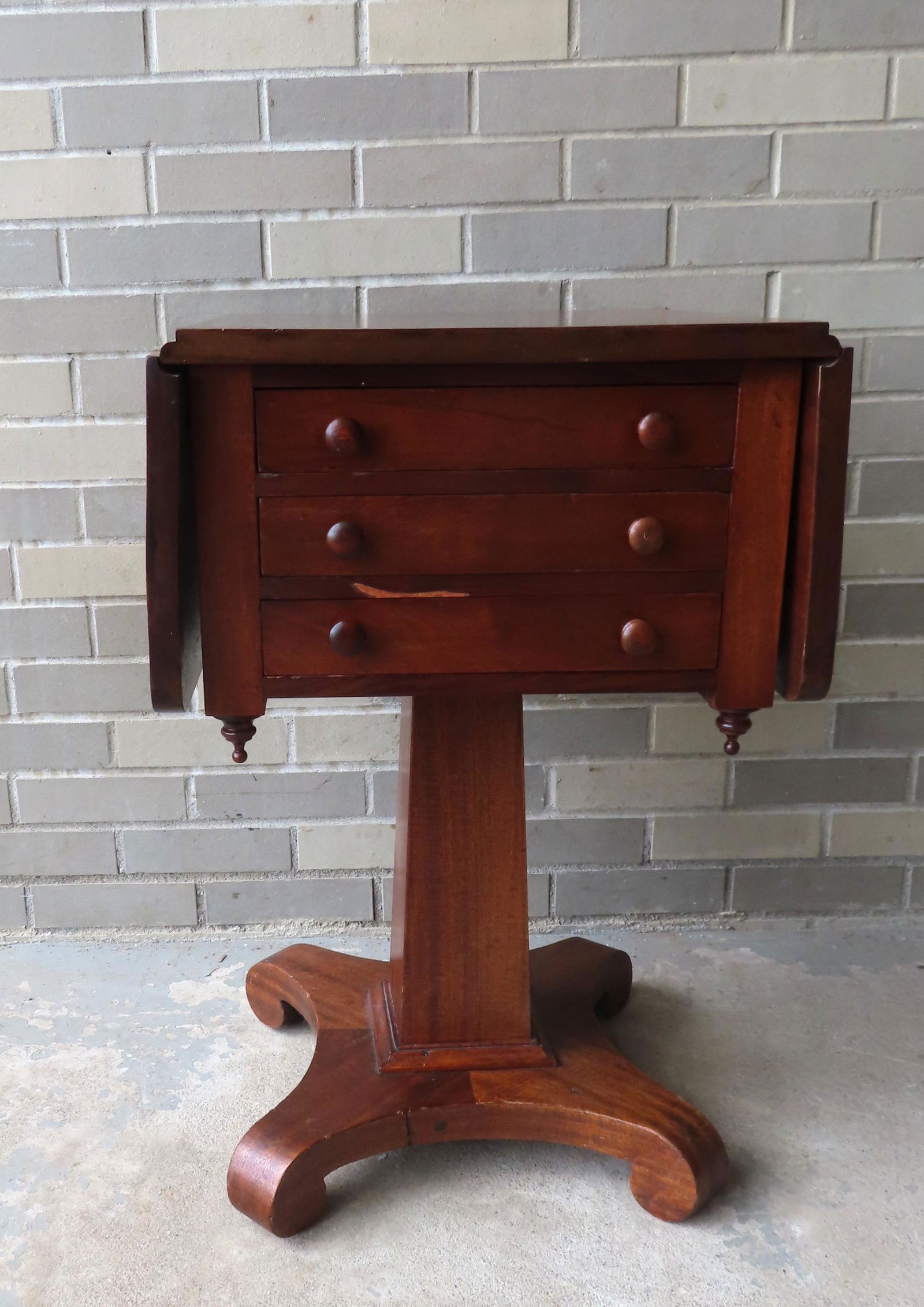 An empire mahogany 3 drawer drop leaf sewing stand on pedestal base with lower platform leading to (1 of 6)