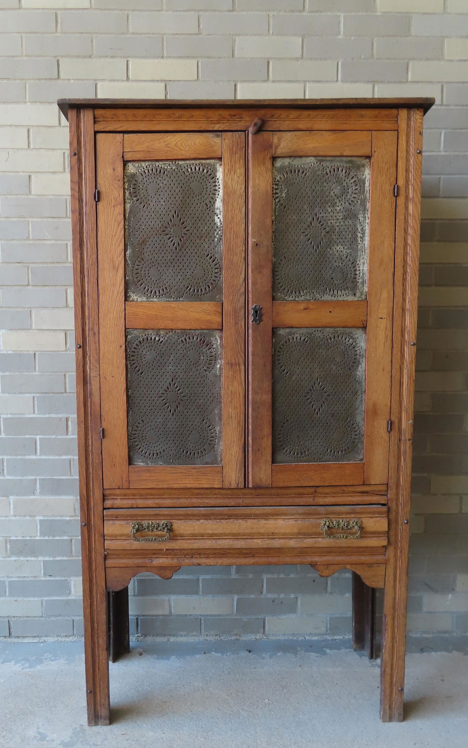 Pierced tin pie safe having 2 doors each with 2 tin panels above a lower drawer, late 19th c. (1 of 8)
