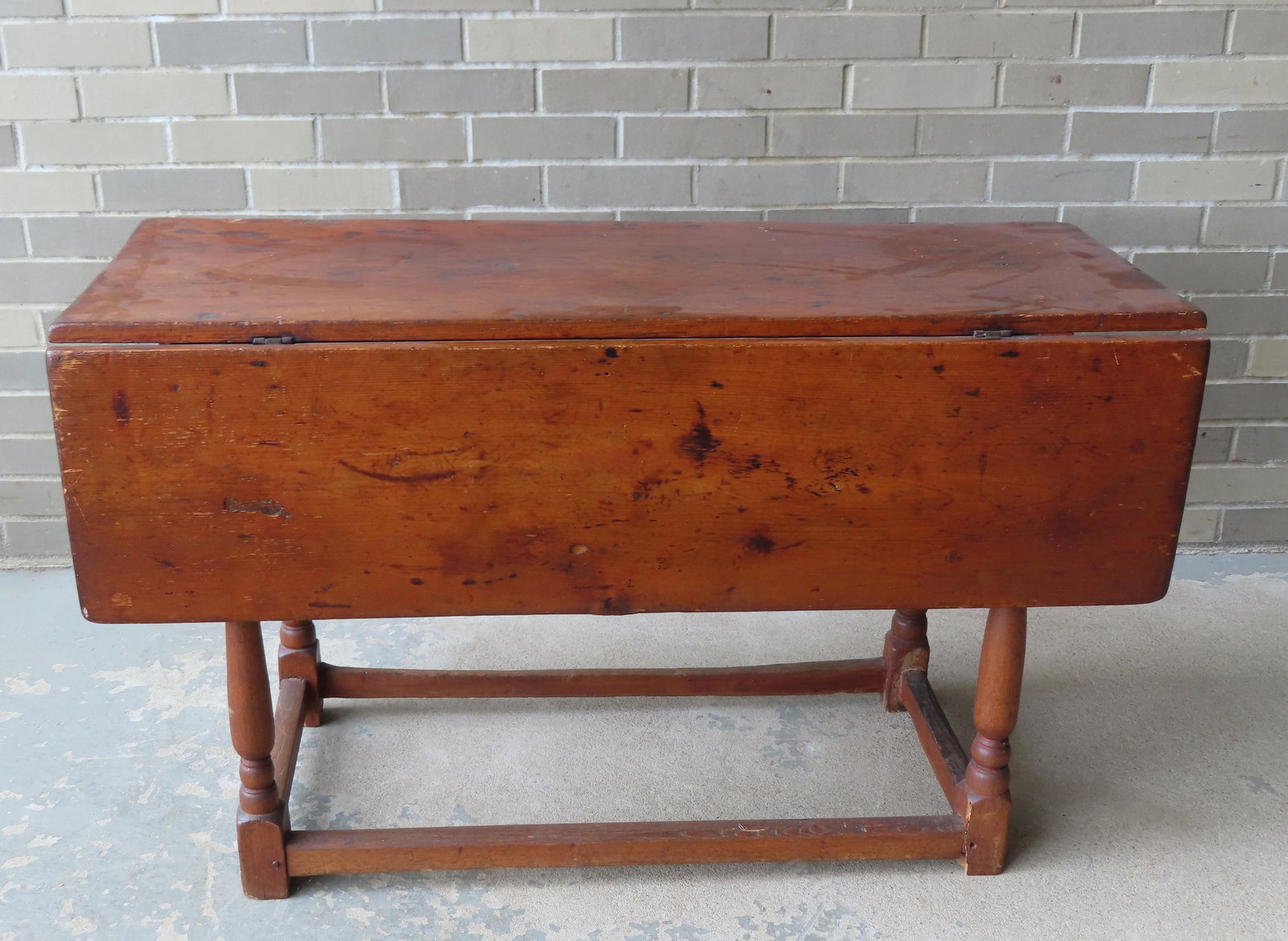 A primitive 18th century drop leaf table with end drawer, turned legs leading to outside stretchers (1 of 15)