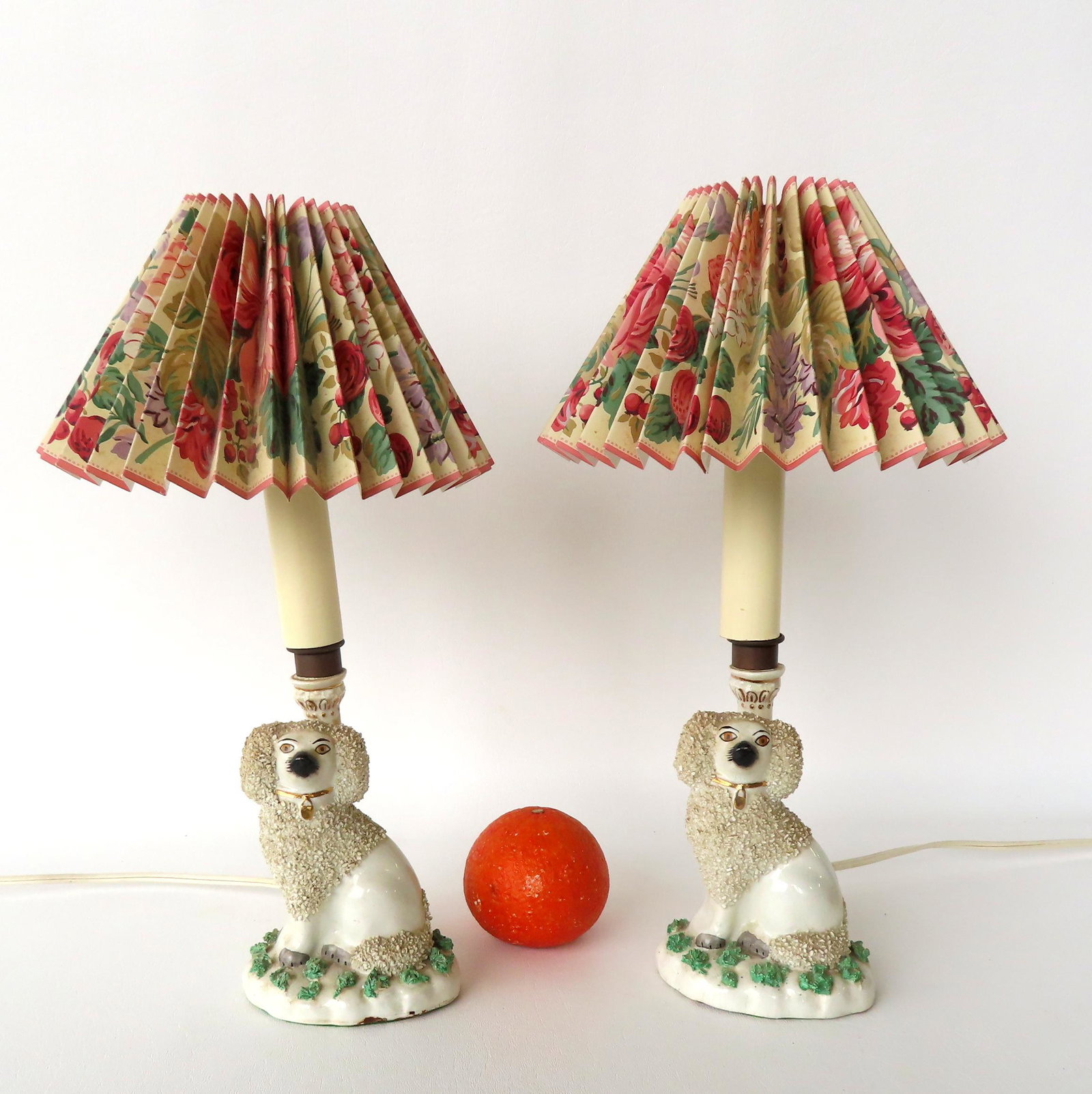 A pair of Staffordshire dog lamps, probably early 20th century - shades are obviously newer and in: A pair of Staffordshire dog lamps, probably early 20th century - shades are obviously newer and in excellent condition. One lamp with repair to post, otherwise both are in very good condition. Each me