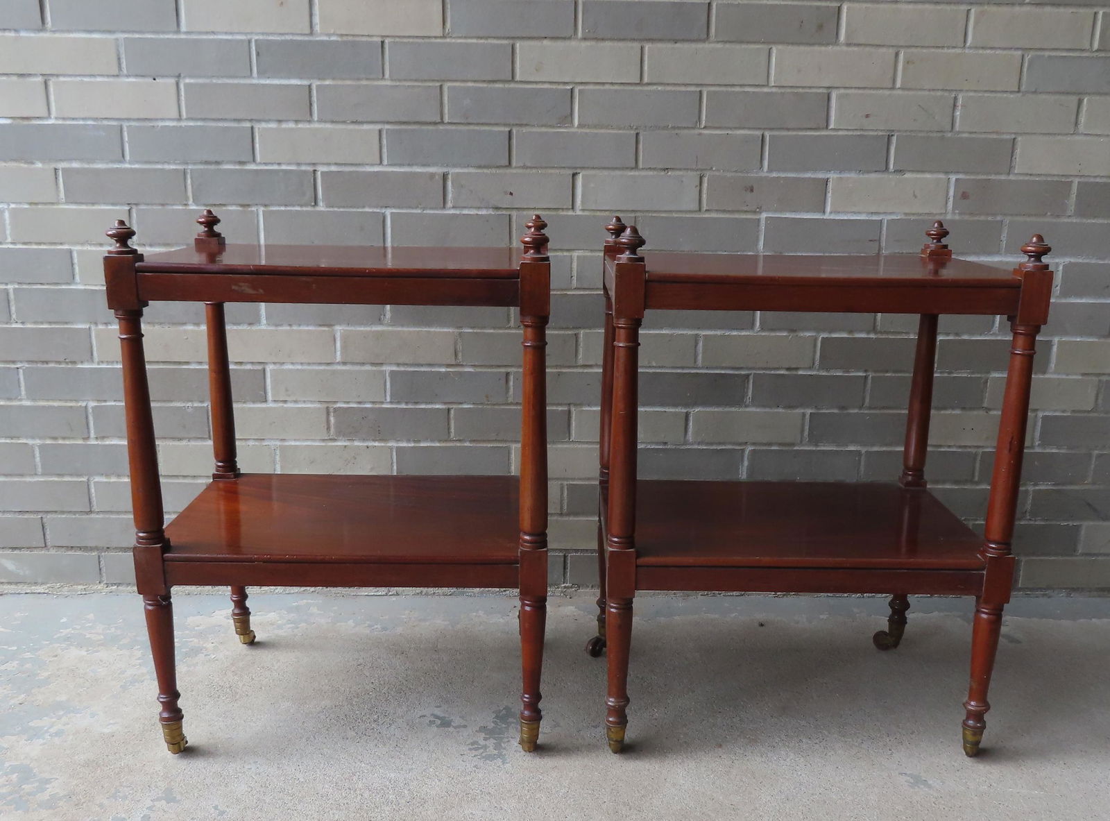 Two Sheraton style mahogany end tables with lower shelves, turned legs leading to brass casters, (1 of 10)