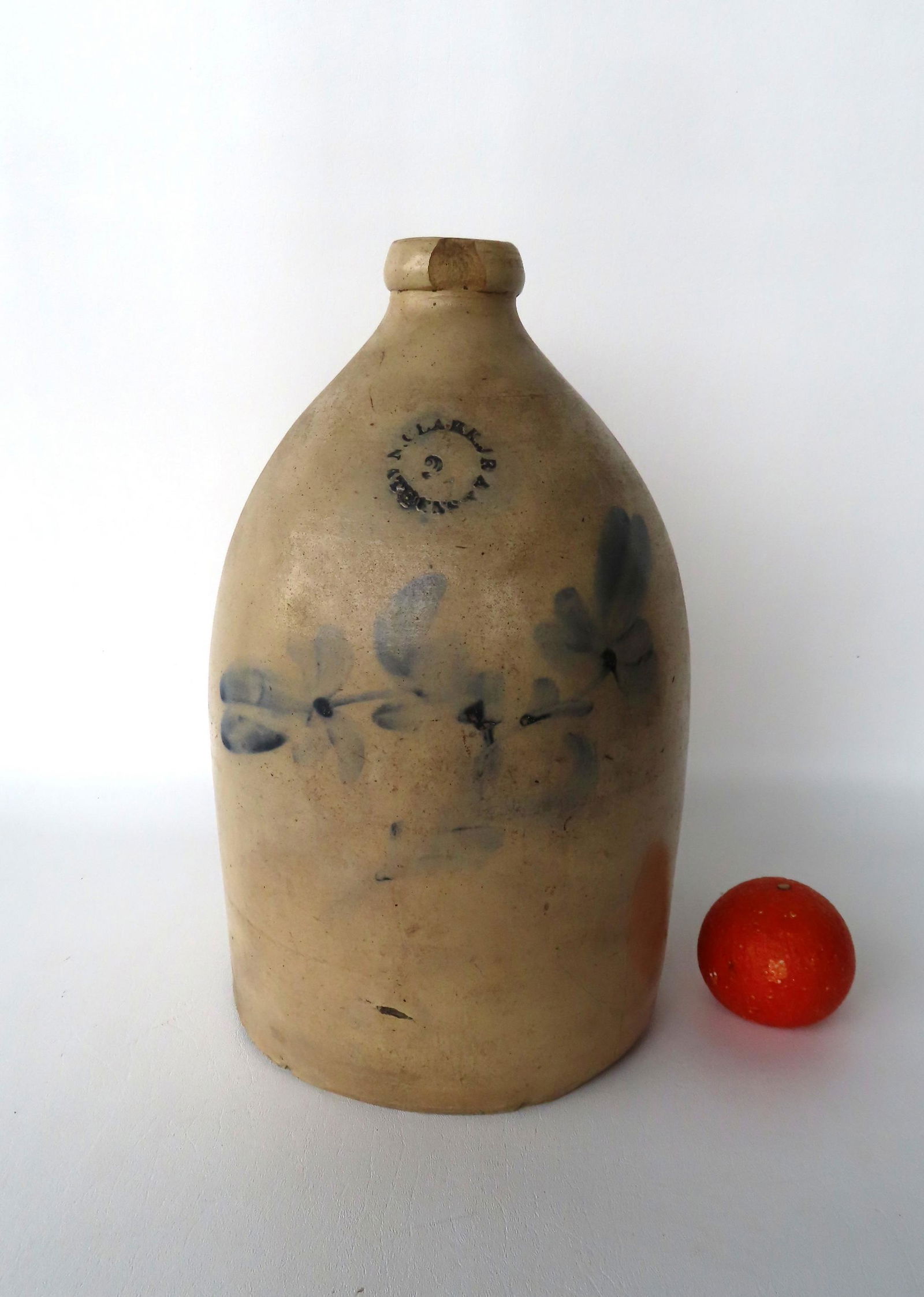 Stoneware 2 gallon jug decorated with a cobalt blue double flower, with the impressed mark of "N. (1 of 6)