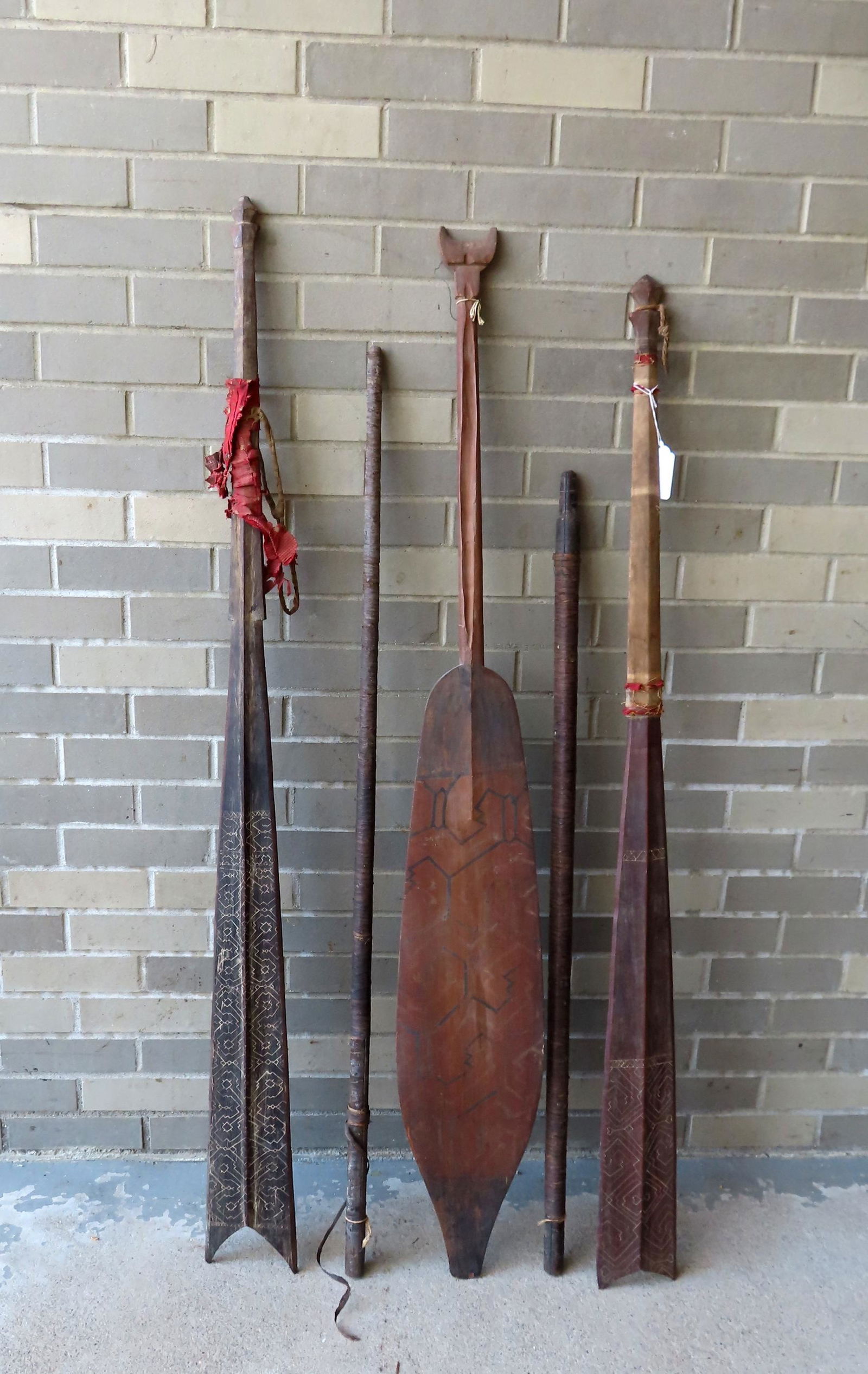 Grouping of 5 ethnographic artifacts, probably African, including: Two blowguns; and 3 paddles in (1 of 8)