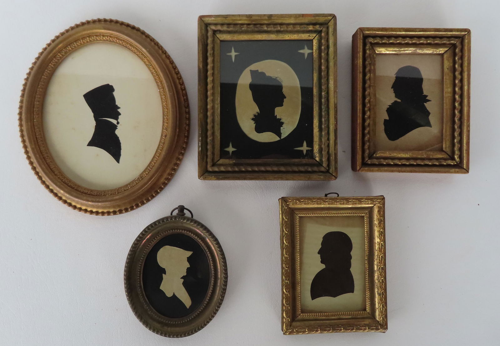 Grouping of five 19th century miniature silhouettes in original gilt frames. The largest measures of (1 of 8)