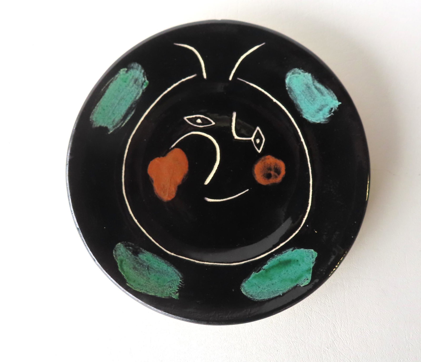 PABLO PICASSO (Spanish 1881-1973). A white earthenware plate from the Service Visage Noir series (1 of 4)