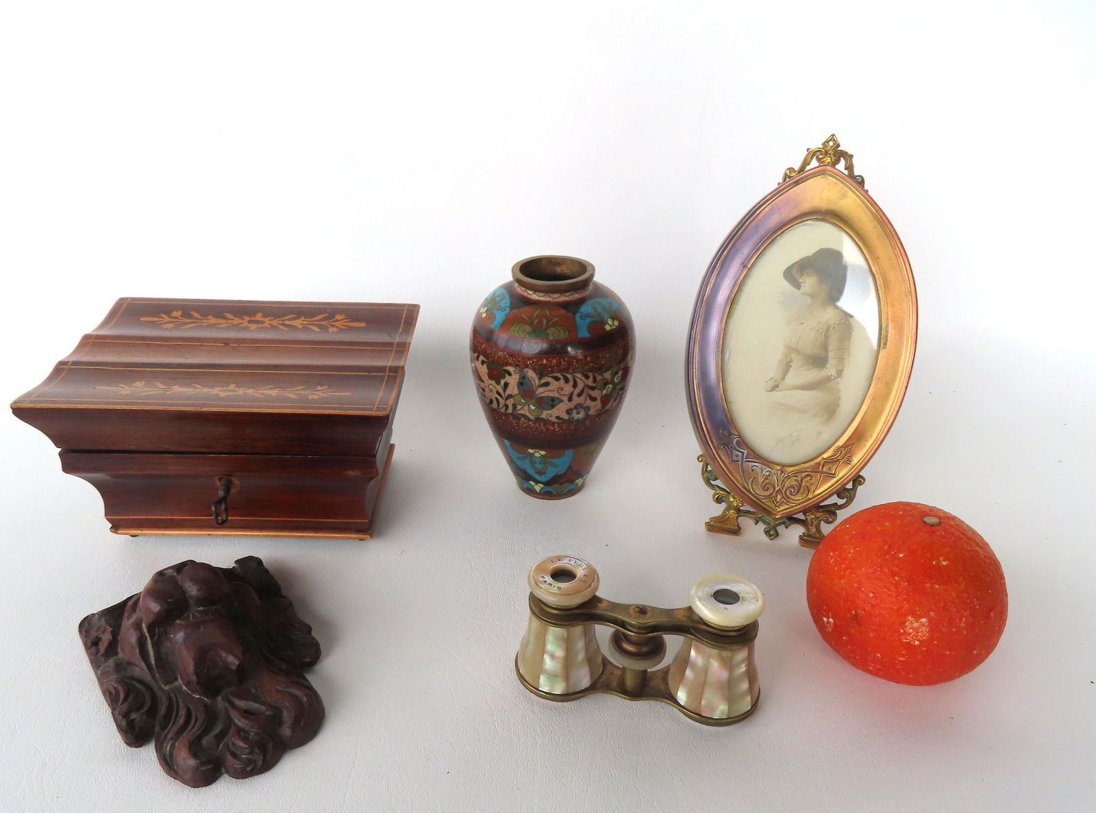 Grouping of decorative objects including: A architectural inlaid mahogany dresser box mounted on: Grouping of decorative objects including: A architectural inlaid mahogany dresser box mounted on tiny ball feet, original lock and key, mid 19th century - the interior with mirror attached to undersid