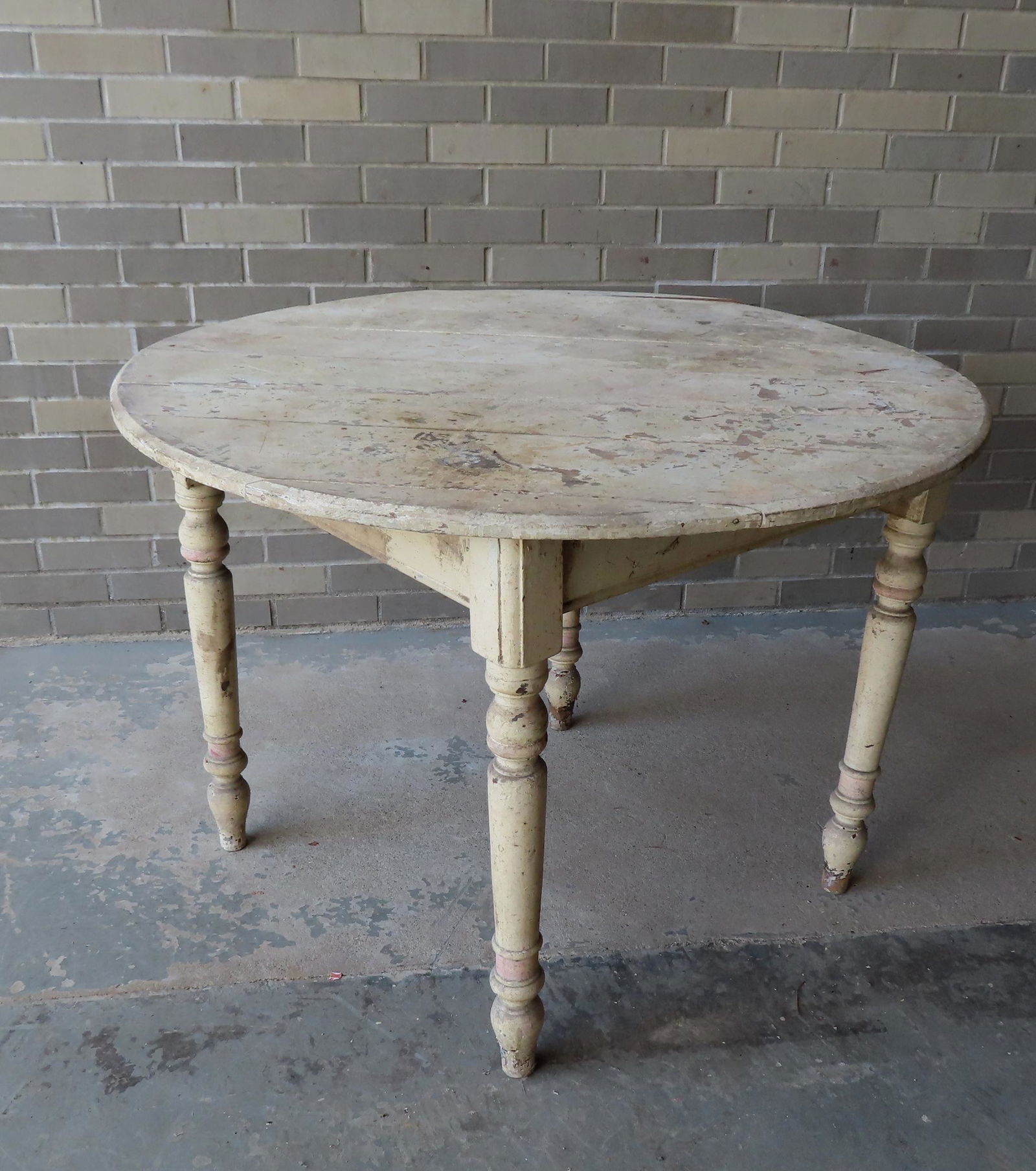 A round primitive kitchen table with turned legs, late 19th century. It appears to have been (1 of 4)