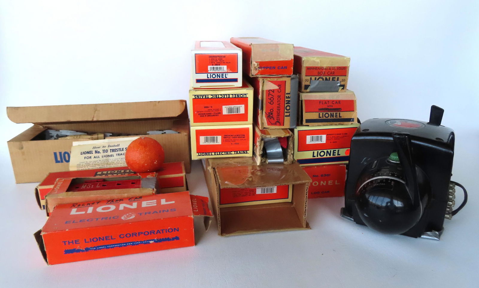 A grouping of Lionel train cars and accessories. The cars, all with original boxes (some boxes with (1 of 20)