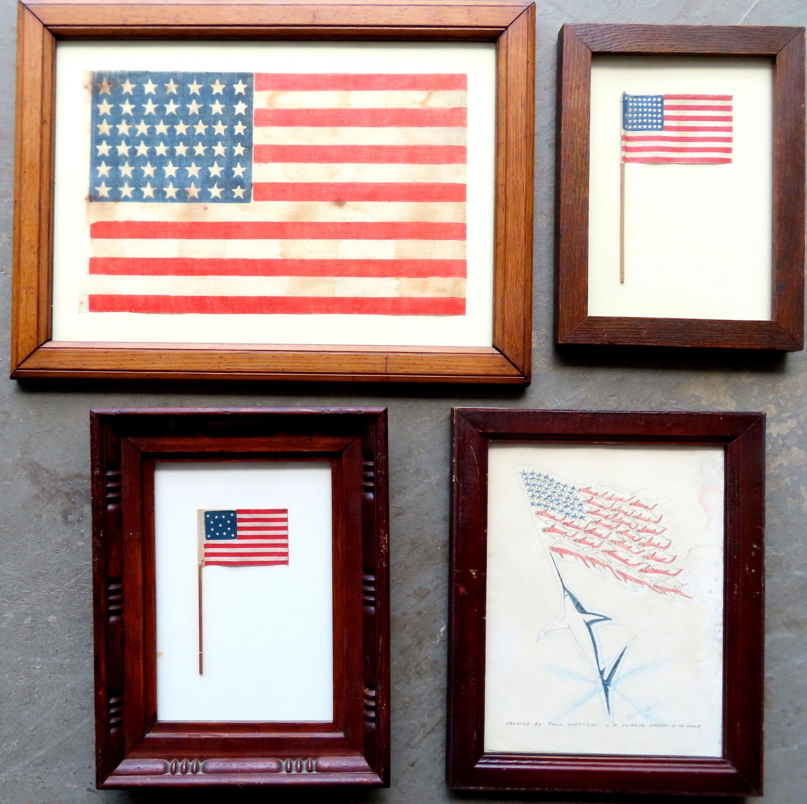 A grouping of 4 framed vintage flags including: A miniature 13 star hand flag printed on cloth and (1 of 6)