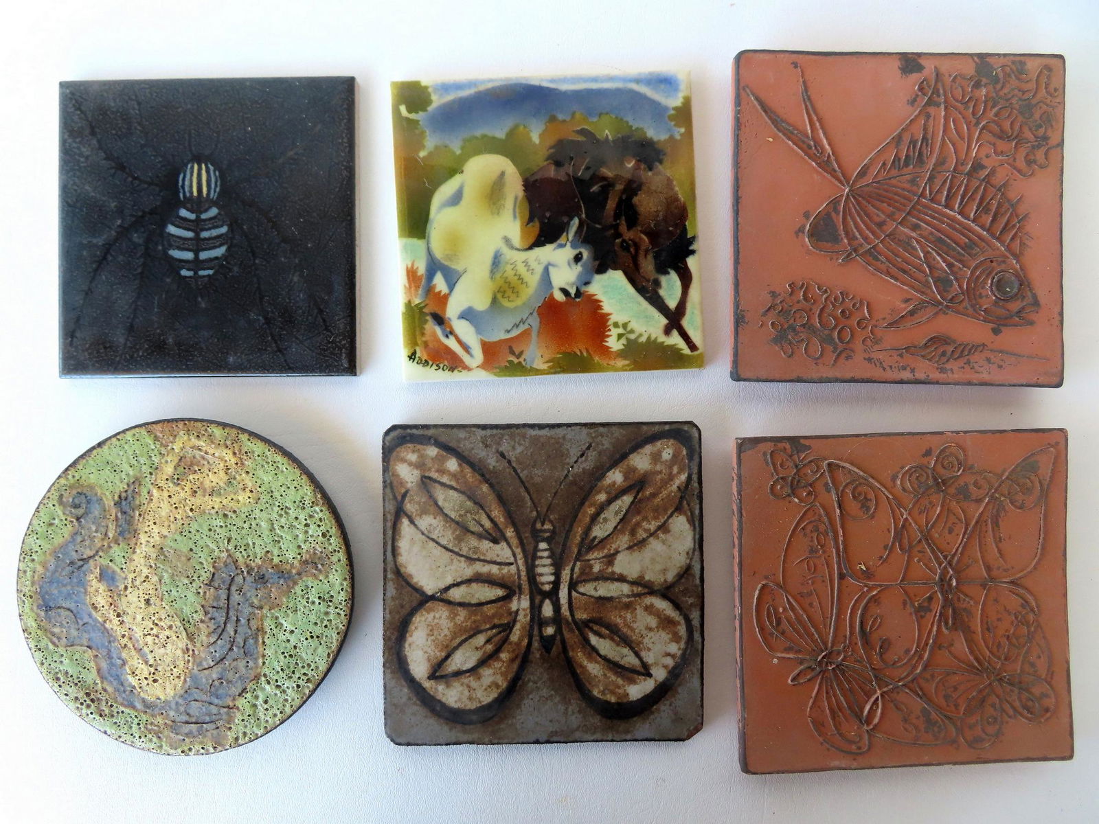 Walter Addison, New York, 1914-1982. Grouping of 6 terra cotta tiles, all hand painted, including (1 of 8)