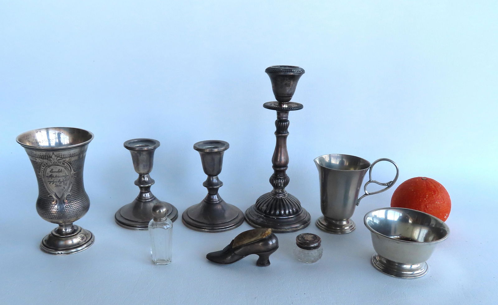 Grouping of silver and pewter objects including: Sterling silver shoe-form pin cushion, 3 weighted (1 of 9)