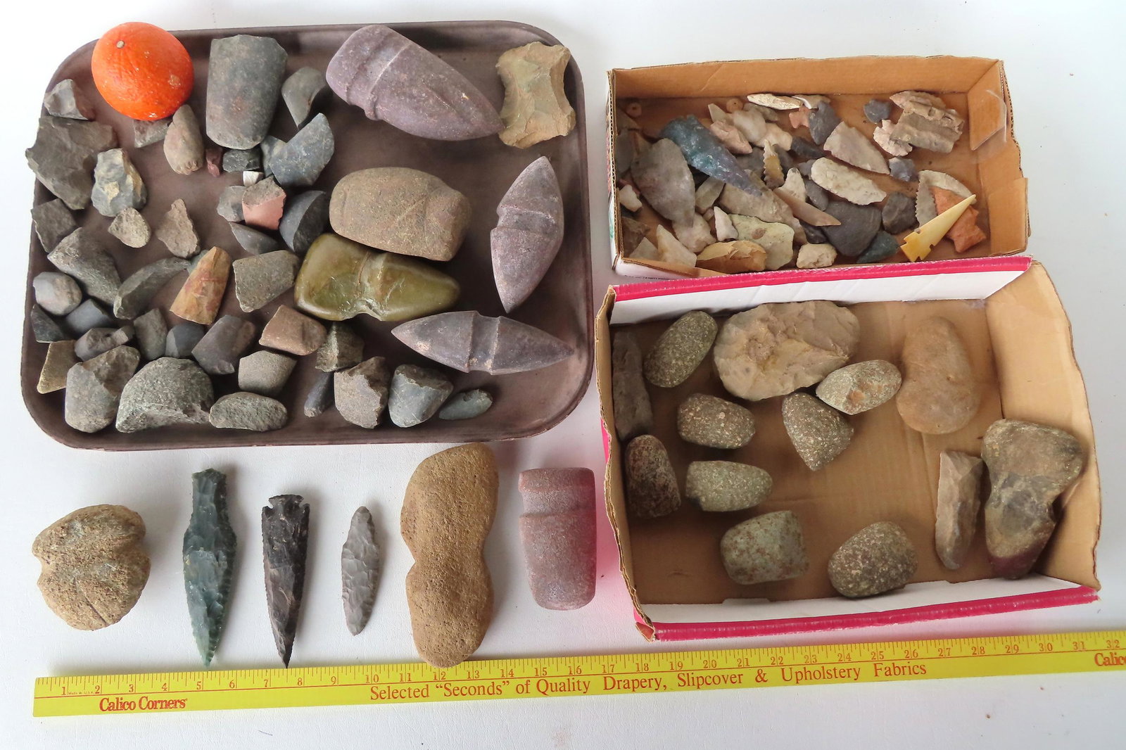 A grouping of Native American stone artifacts including arrowheads, ax heads, etc. See photos for (1 of 7)