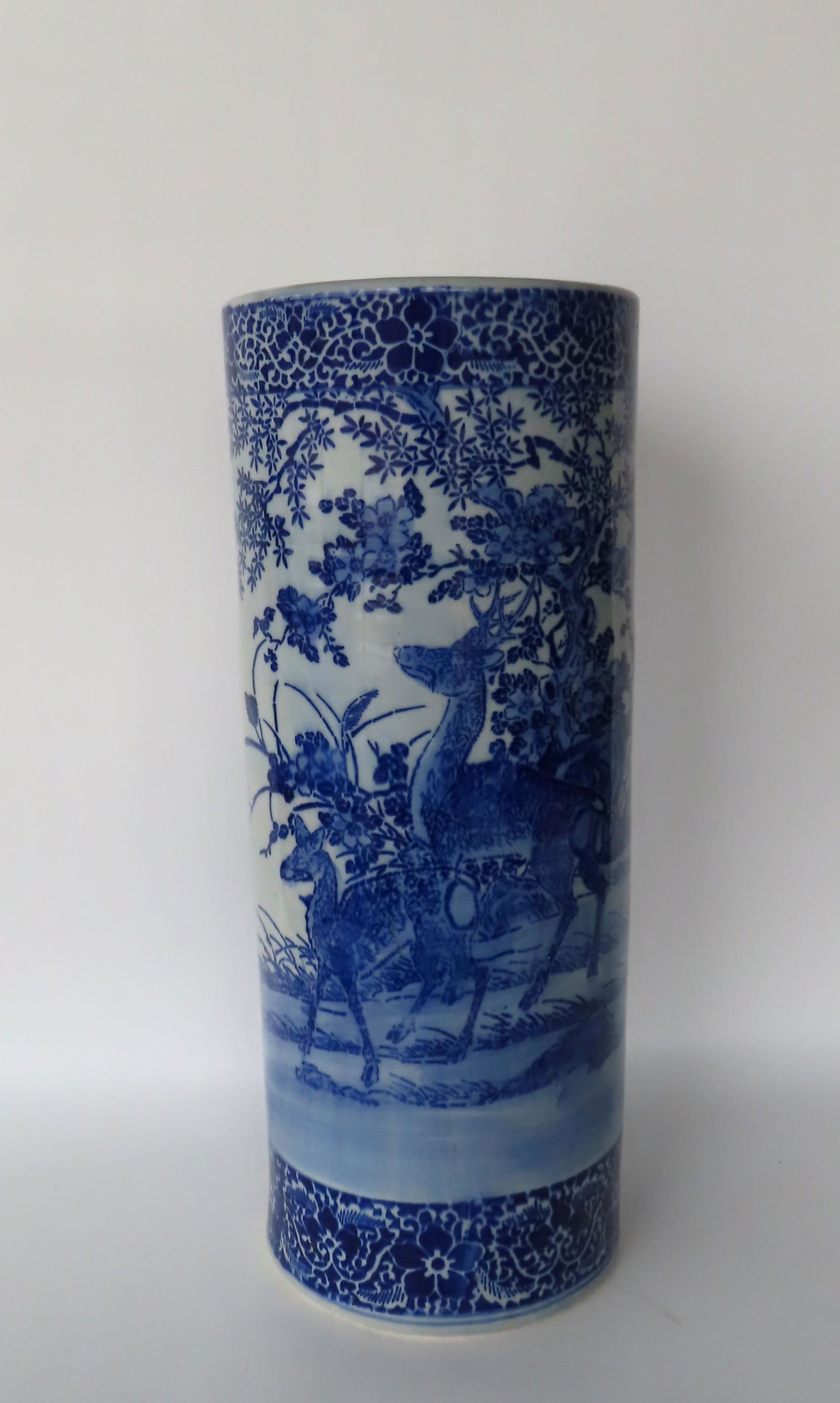 A blue and white oriental style porcelain umbrella stand decorated with stags in the woods, probably (1 of 4)