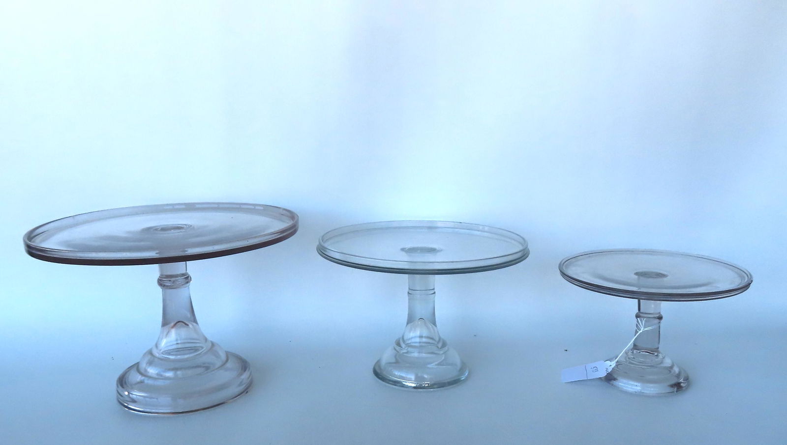 Grouping of 3 pressed glass cake stands on pedestal bases in graduated sizes from 9" diameter x 6"H (1 of 4)