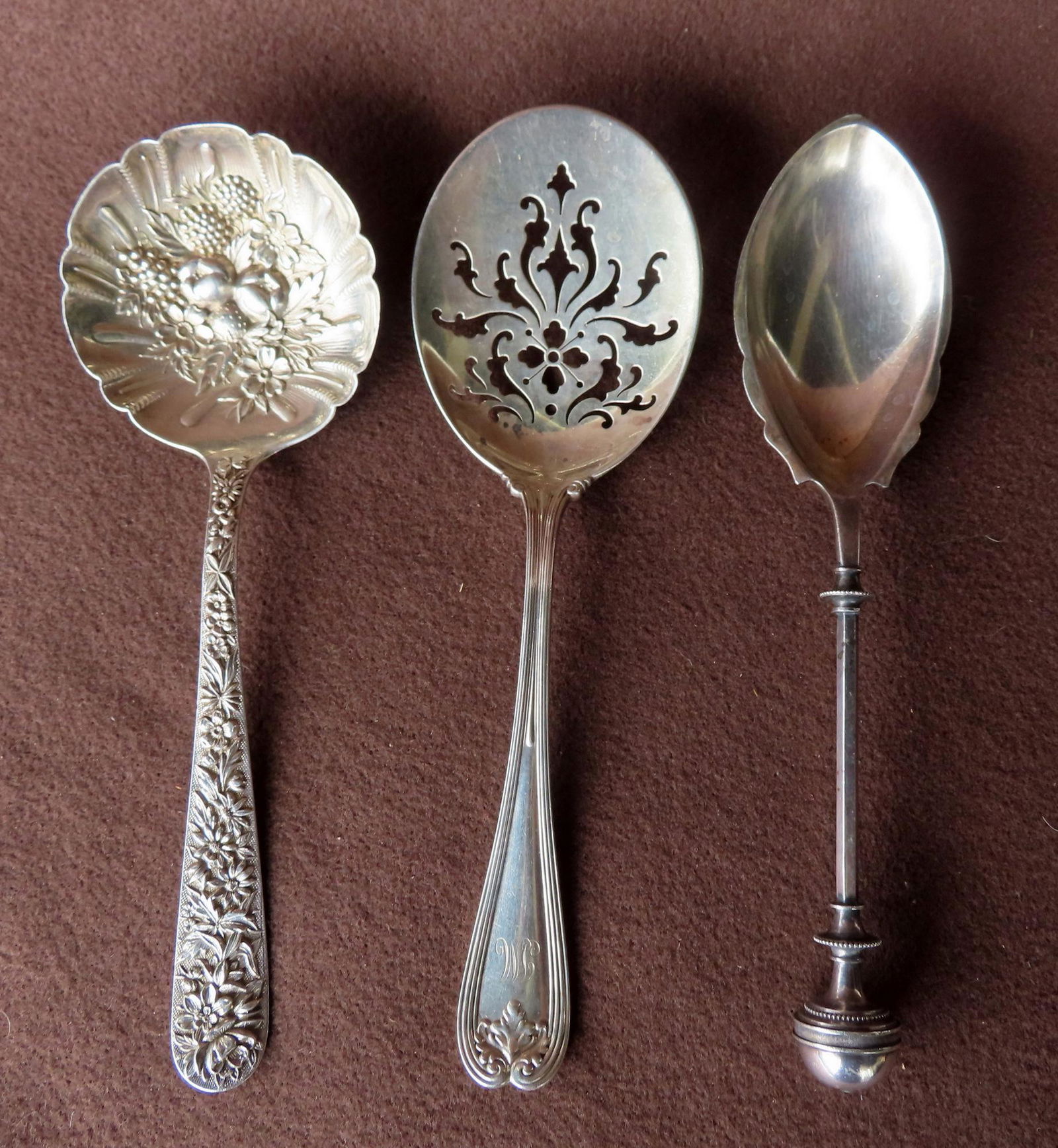 Three ornate serving spoons including: Tiffany & Co., Browne Spaulding & Co., and S. Kirk & Son with (1 of 8)