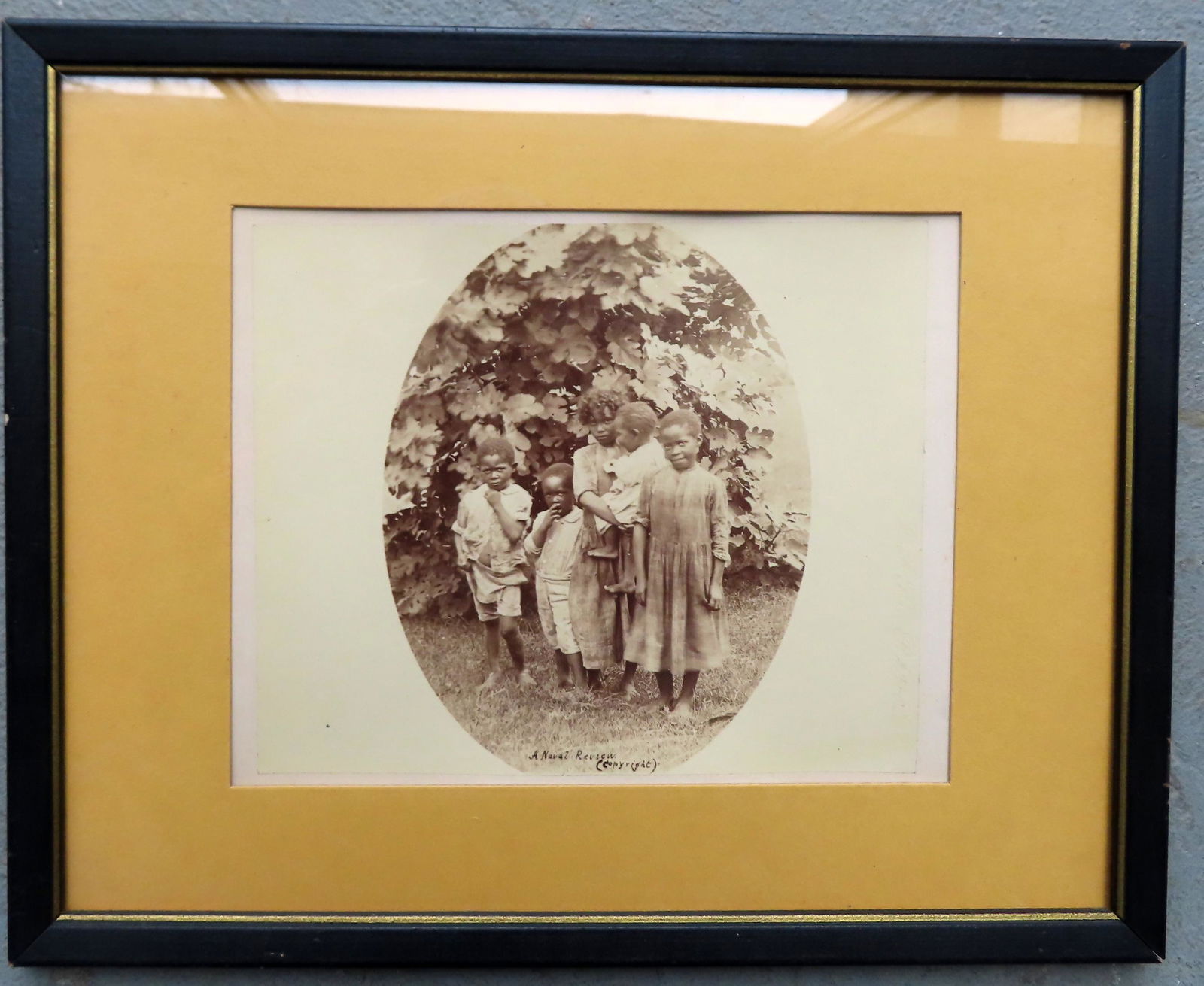 A framed platinum print of 5 African American children titled in ink "A Naval Review (Copyright)".: A framed platinum print of 5 African American children titled in ink "A Naval Review (Copyright)". Size of paper 8 5/8" x 7 1/4" and total frame size 12" x 15". Very good condition, late 19th century,