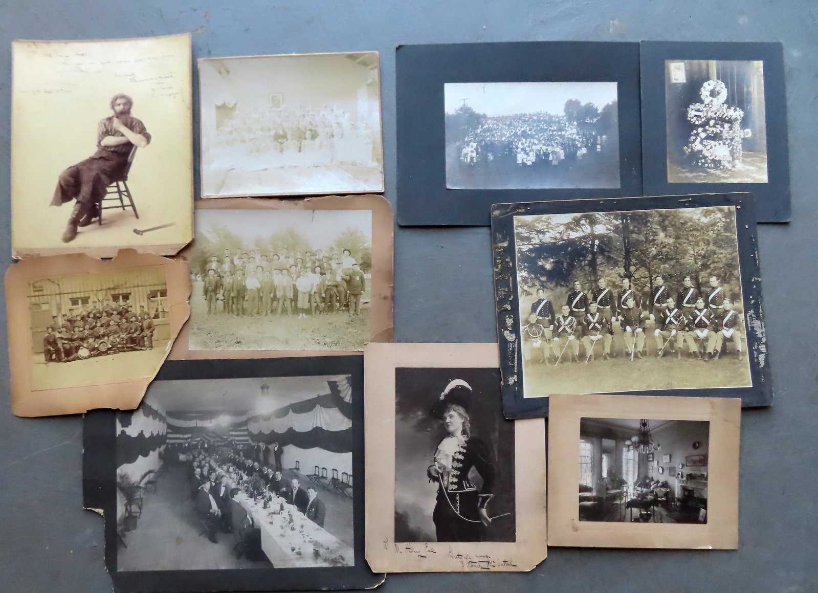 Grouping of 10 large folio photographs including: Cadets in uniform holding swords, late 19th: Grouping of 10 large folio photographs including: Cadets in uniform holding swords, late 19th century - 13 1/2" x 16 3/4"; patriotic banquet with all male audience; photo of military men holding mug o