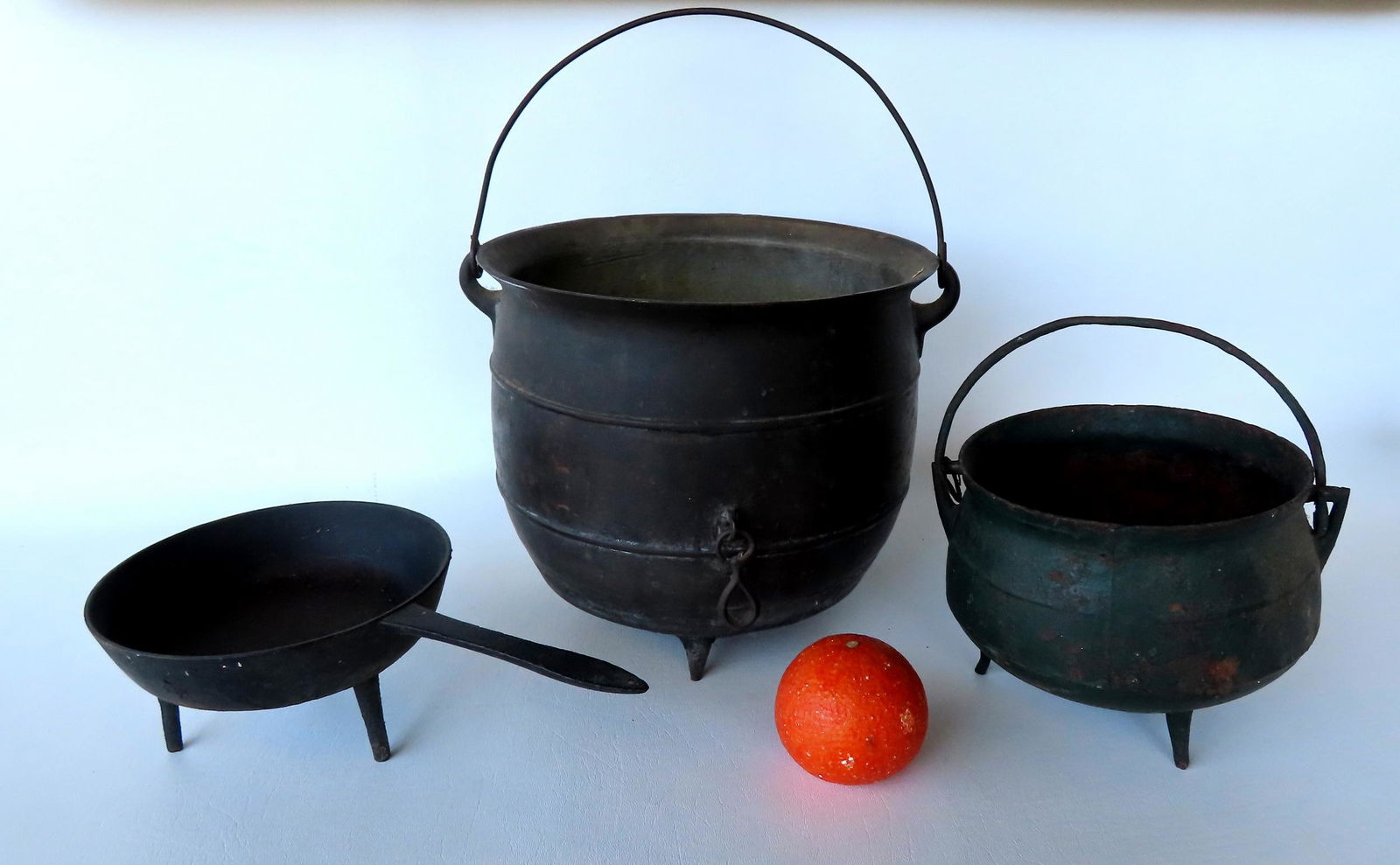 Three cast iron tri-foot hearth items, 19th century. (1 of 8)
