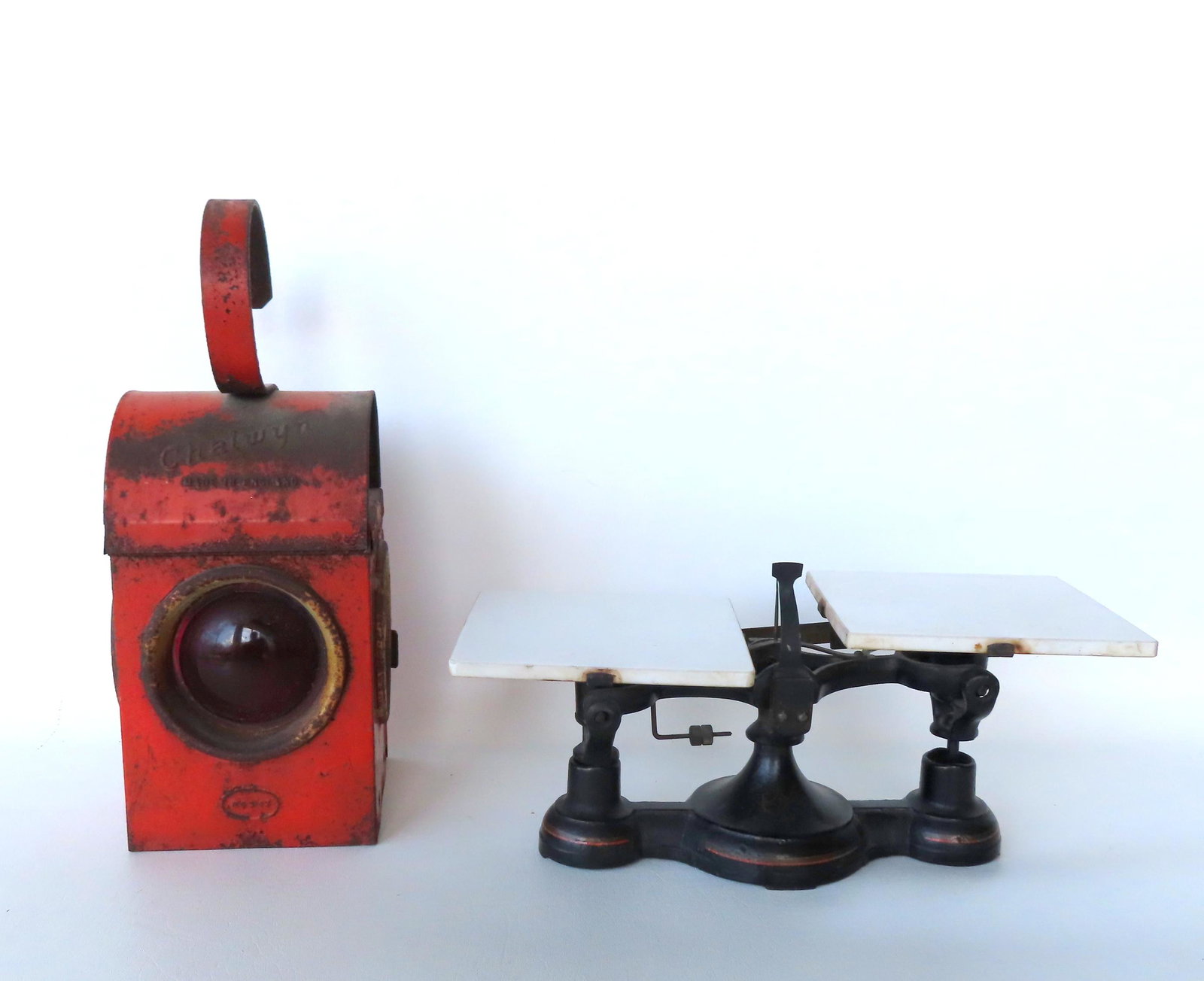 Balance scale plus RR lantern.: Two country collectibles including: A balance scale with milk glass platforms - original paint and stenciling in good condition - measures 14"W x 7"H; and a Chalwyn (Made in England) railroad lantern 