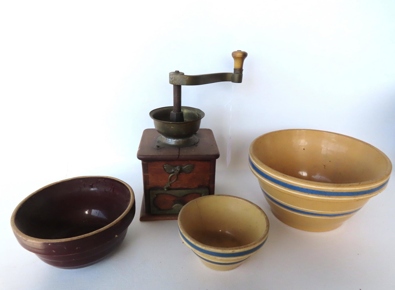 Grouping of country collectibles, late 19th to early 20th century.: Grouping of country collectibles, late 19th to early 20th century. Includes 3 mixing bowls, the small with hairline, others in good condition and a coffee mill in good condition.