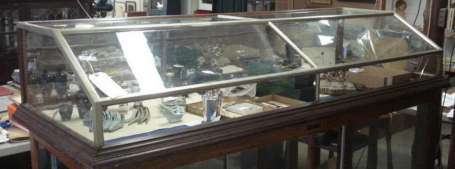 Large table top country store showcase with slante: Large table top country store showcase with slanted glass top, mirror back, 3 drop-down draws in back. 19th century. 74.5"W x 27.5"D x 14"H. Deassessioned from Historic Huguenot Museum, New Paltz, NY