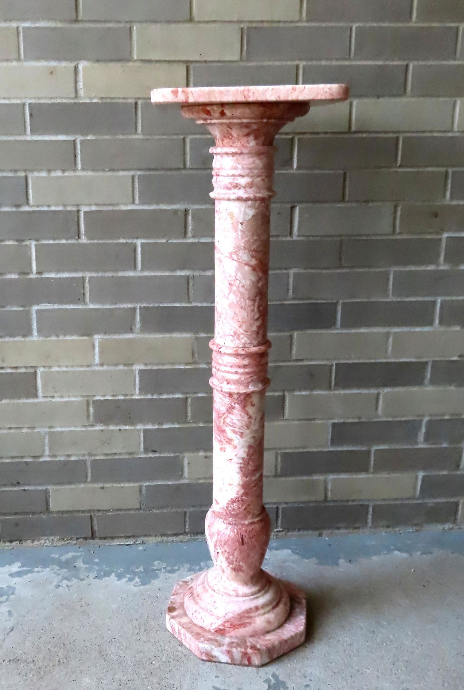 A pink, white & gray marble pedestal having a square top with rounded corners which attaches to a (1 of 8)