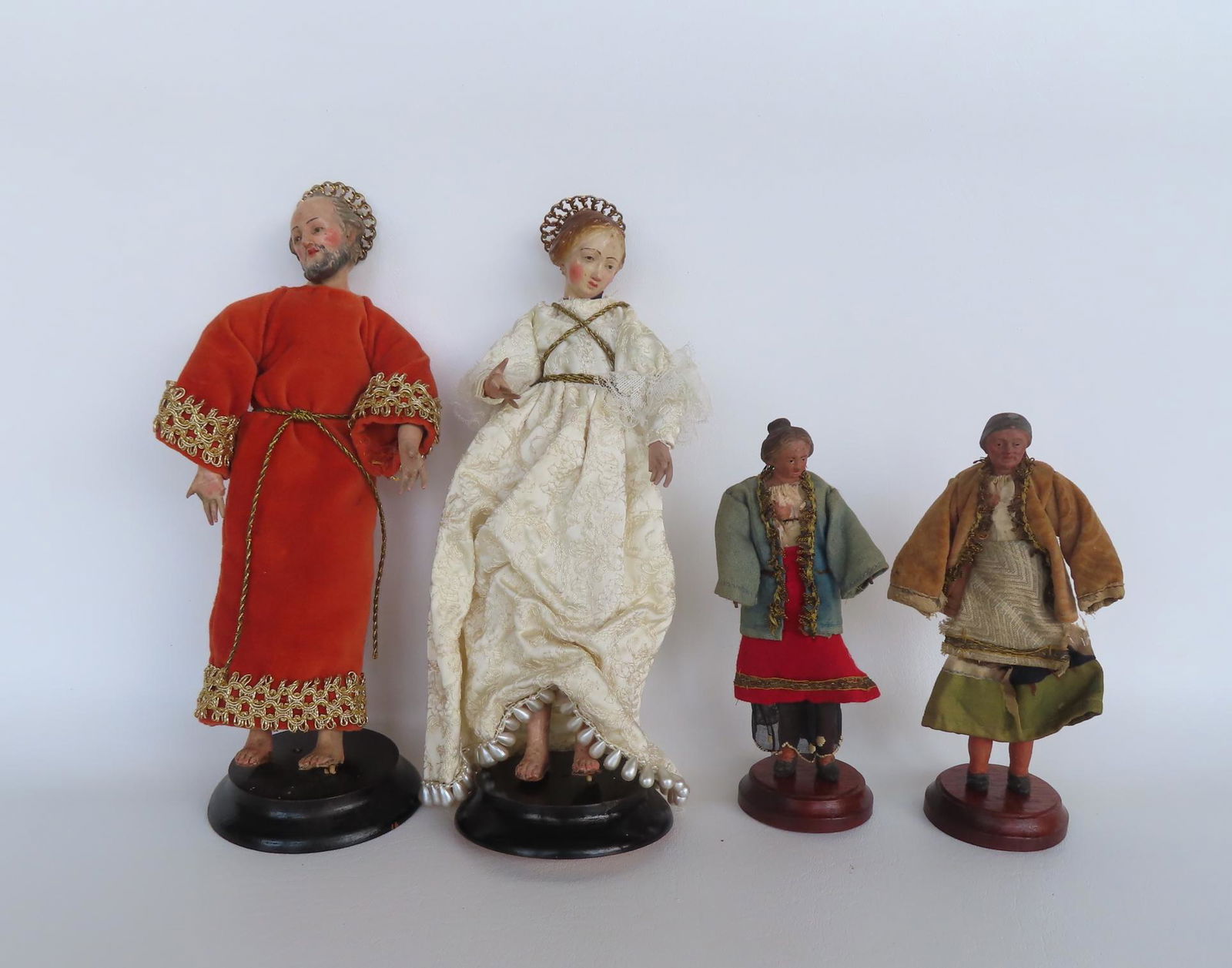 Four early terra cotta sculptures including: Two hand painted religious sculptures, man and woman, (1 of 11)