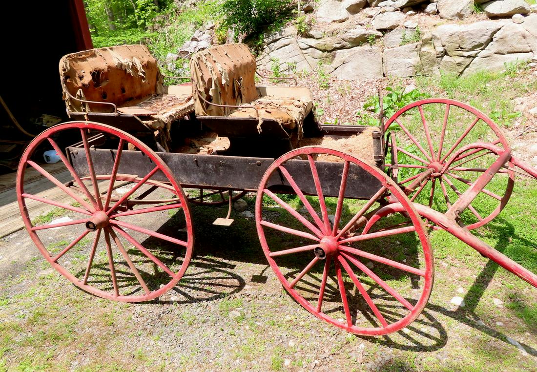 A double-seat buckboard having large wooden wheels in old red paint and body in a blue/green paint - (1 of 7)