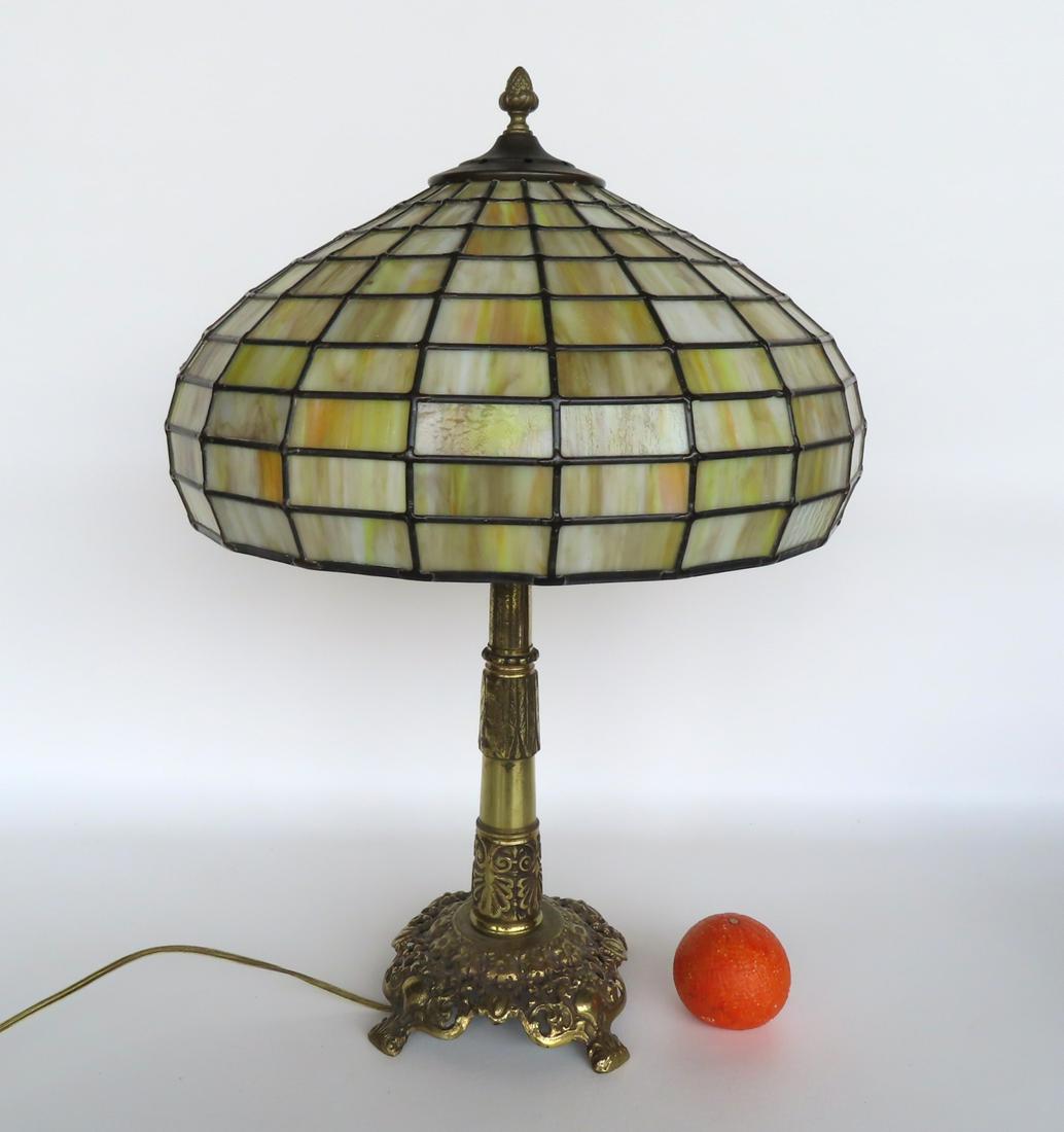 A leaded and slag glass table lamp with a fancy brass base, early to mid 20th century. The column (1 of 11)
