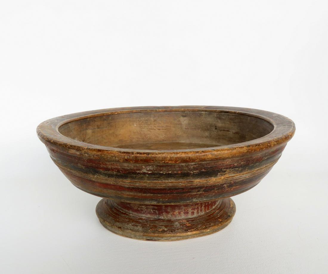 A primitive hand turned bowl with footed base rolled rim, concentric lines around body, and in (1 of 7)