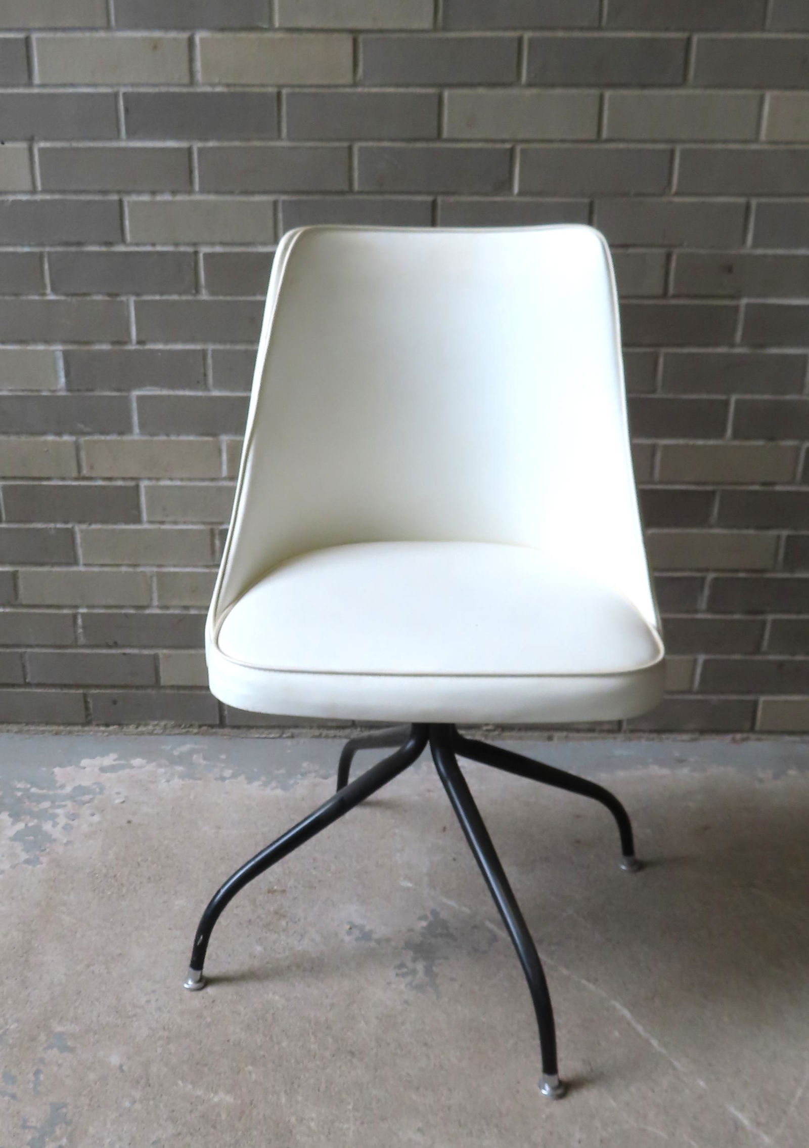 A mid-century modern style white leather desk chair with swivel seat mounted on 4 metal spider legs, (1 of 6)