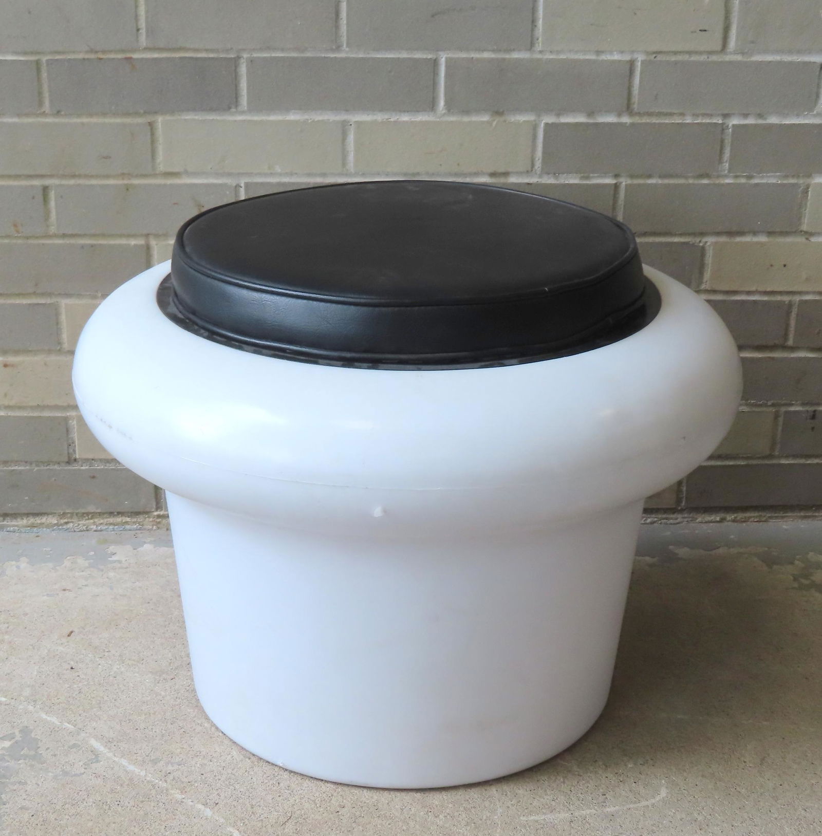 A mid-century modern style white plastic stool with leather seat pad, circa 1970 or later. Very good (1 of 4)