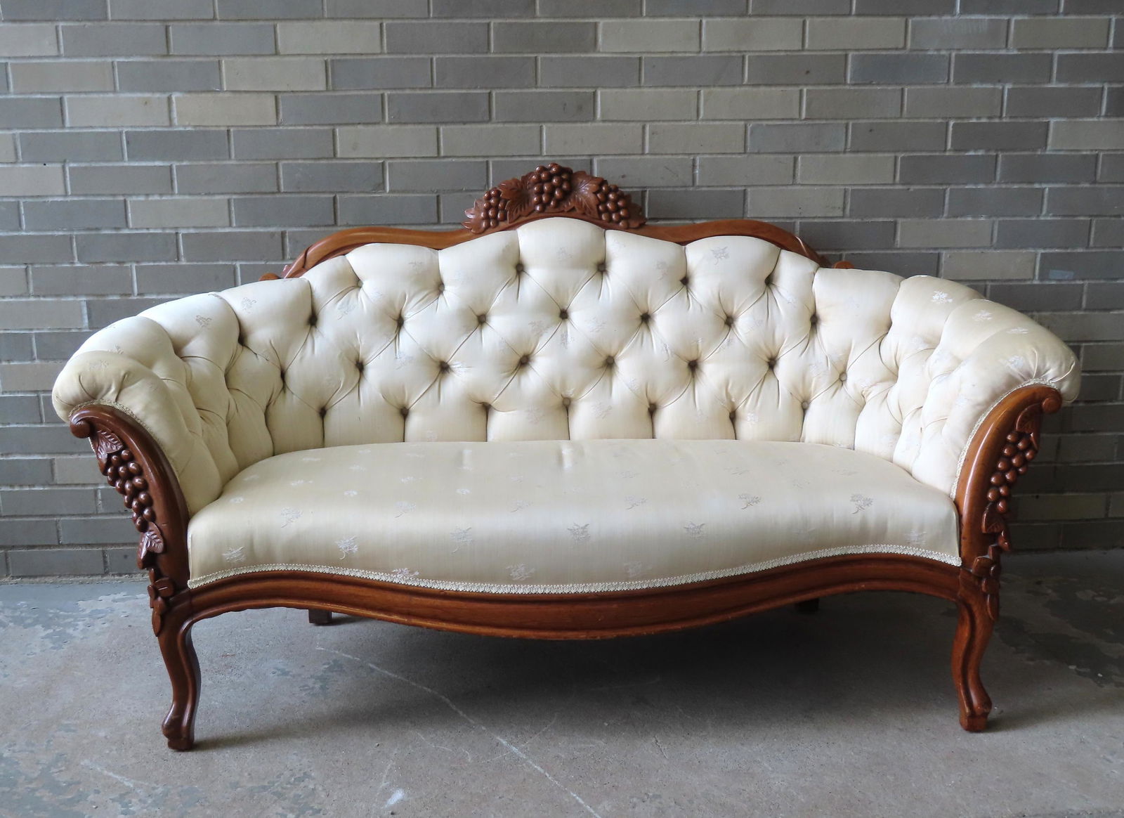 A beautiful Victorian tufted sofa having a black walnut frame with grape and leaf pattern carvings (1 of 7)