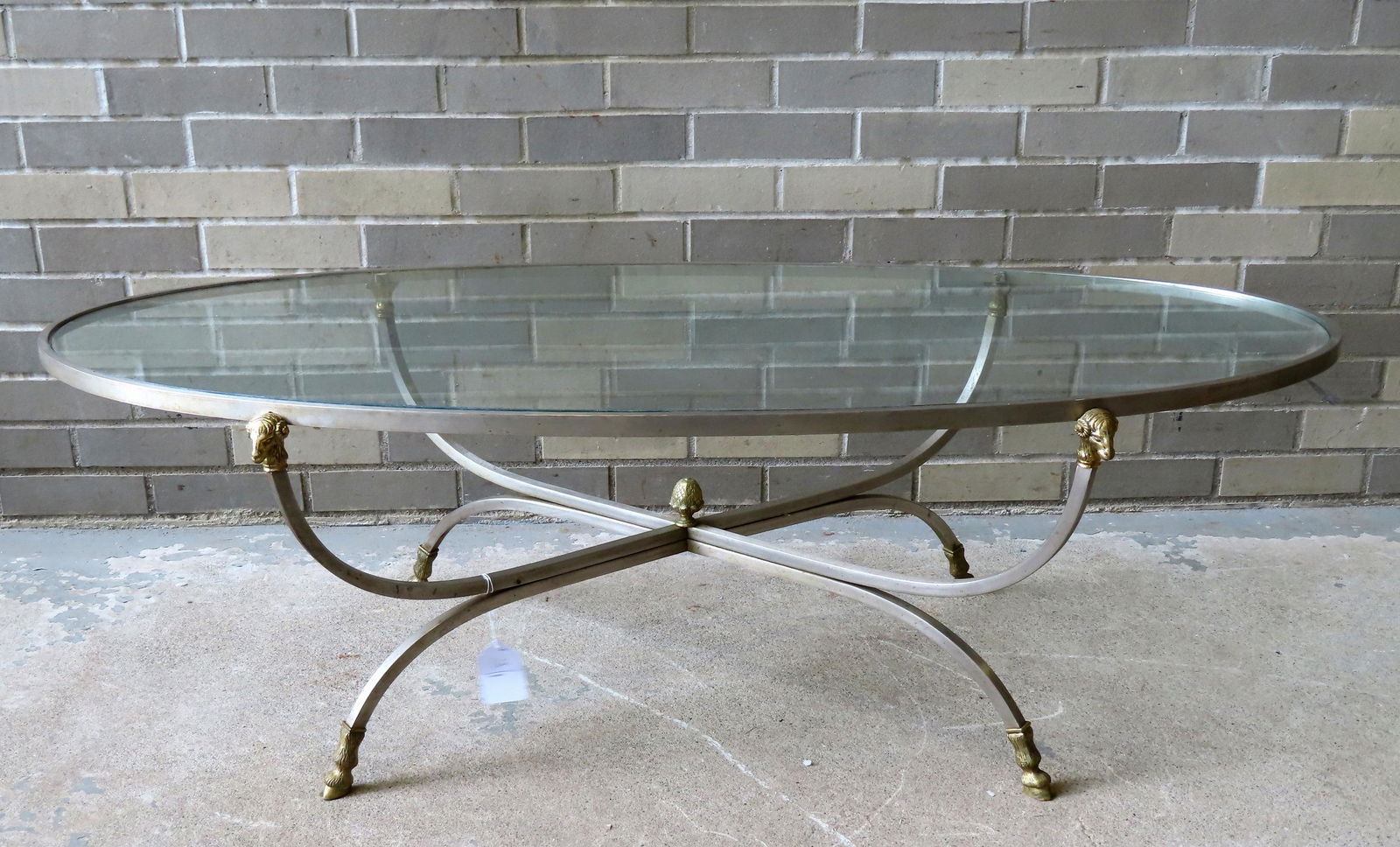 A very fine polished steel coffee table with glass top adorned with brass ram's heads and ram's (1 of 5)