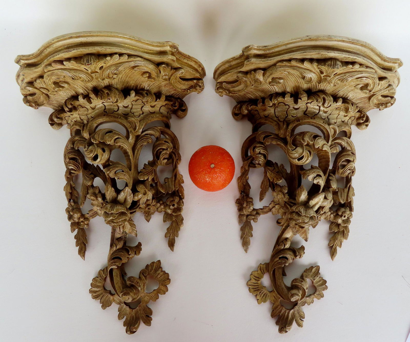 A pair of ornate rococo style wall shelves decorated with scrolls and flowers and having a shaped (1 of 14)