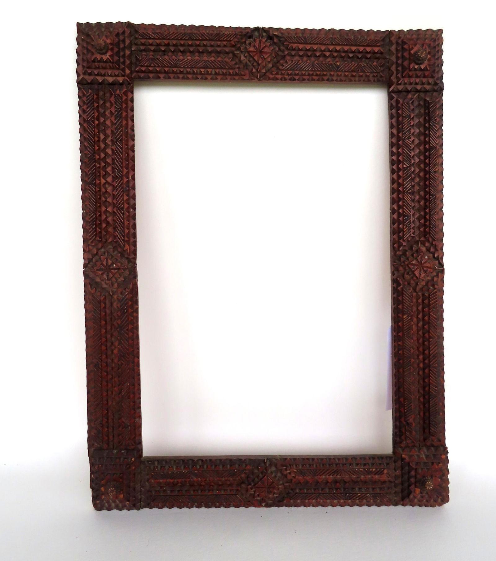 A 19th century tramp art frame. Overall size 17 1/2" x 23 1/8" and opening 12 7/8" x 20". Missing 2 (1 of 6)